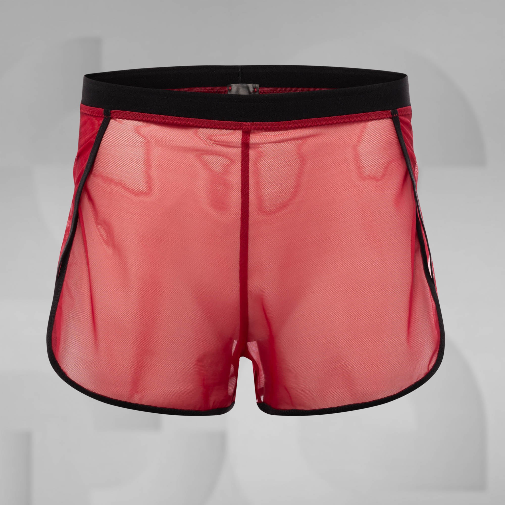 Red athletic shorts with black trim on a gray background