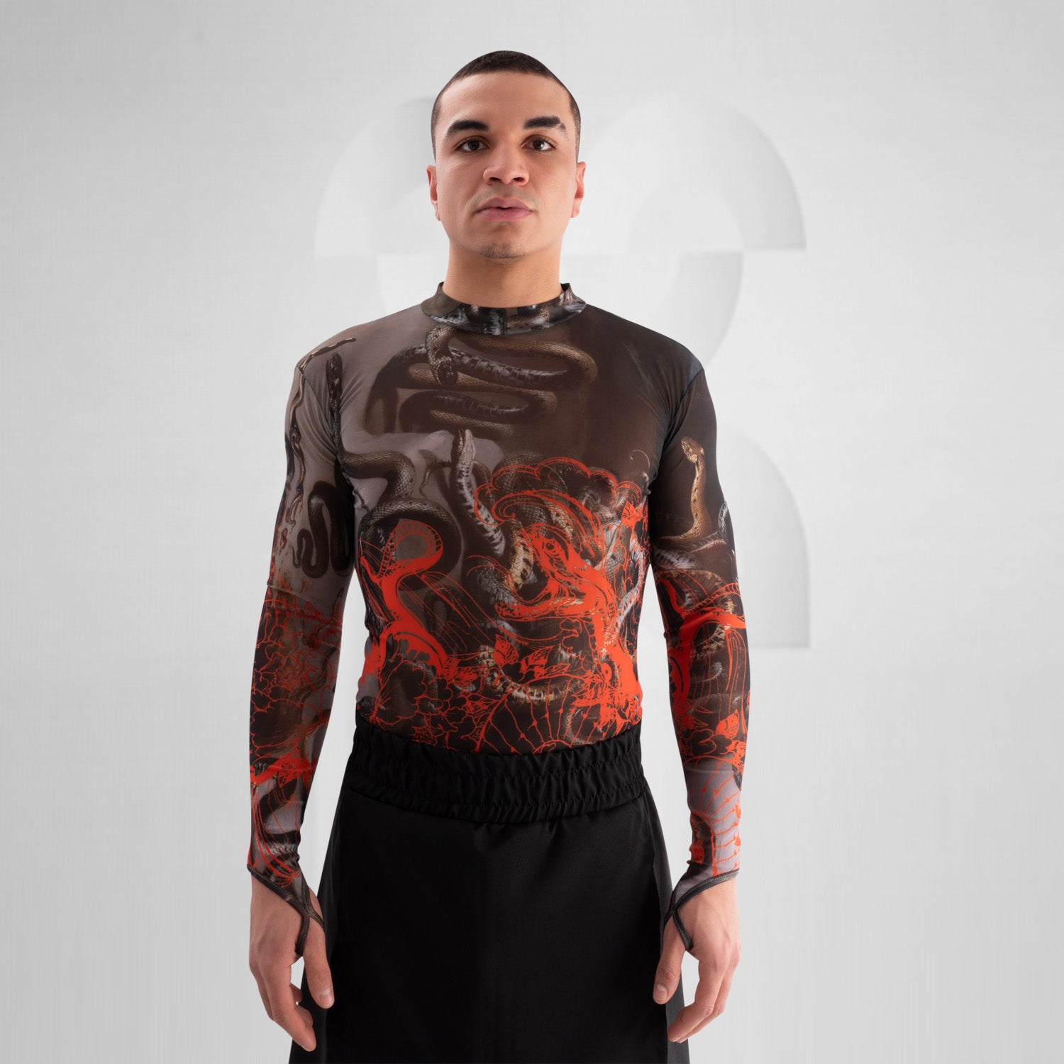 The image showcases a striking outfit featuring a long-sleeve top with an eye-catching design of swirling octopuses in dark hues, accented with vibrant red. The top is complemented by unique metallic neck detailing that adds an edgy flair. Paired with black high-waisted shorts featuring cut-out details, this look exudes confidence and individuality. Ideal for making a statement on the dancefloor or at a fashion-forward event, the ensemble beautifully blends art and style for a captivating appearance.