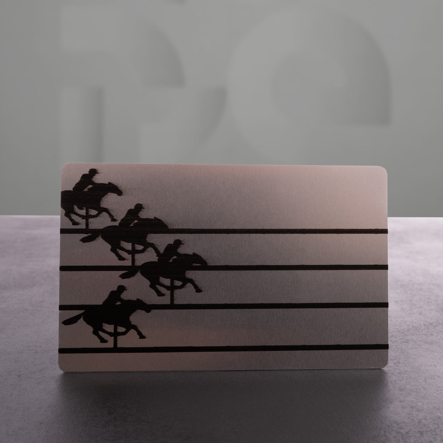 This image features a stylish card with a striking design showcasing a powerful horse graphic alongside "The Code" logo. The metallic finish adds an edgy touch, making it a chic accessory. Perfect for making a statement, this card embodies the spirit of boldness and sophistication!