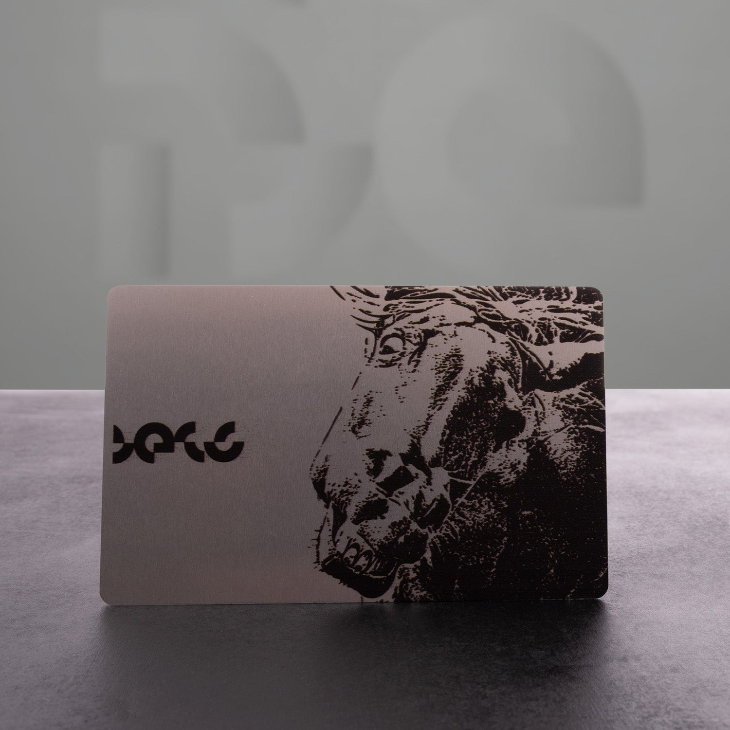 This image features a stylish card with a striking design showcasing a powerful horse graphic alongside "The Code" logo. The metallic finish adds an edgy touch, making it a chic accessory. Perfect for making a statement, this card embodies the spirit of boldness and sophistication!
