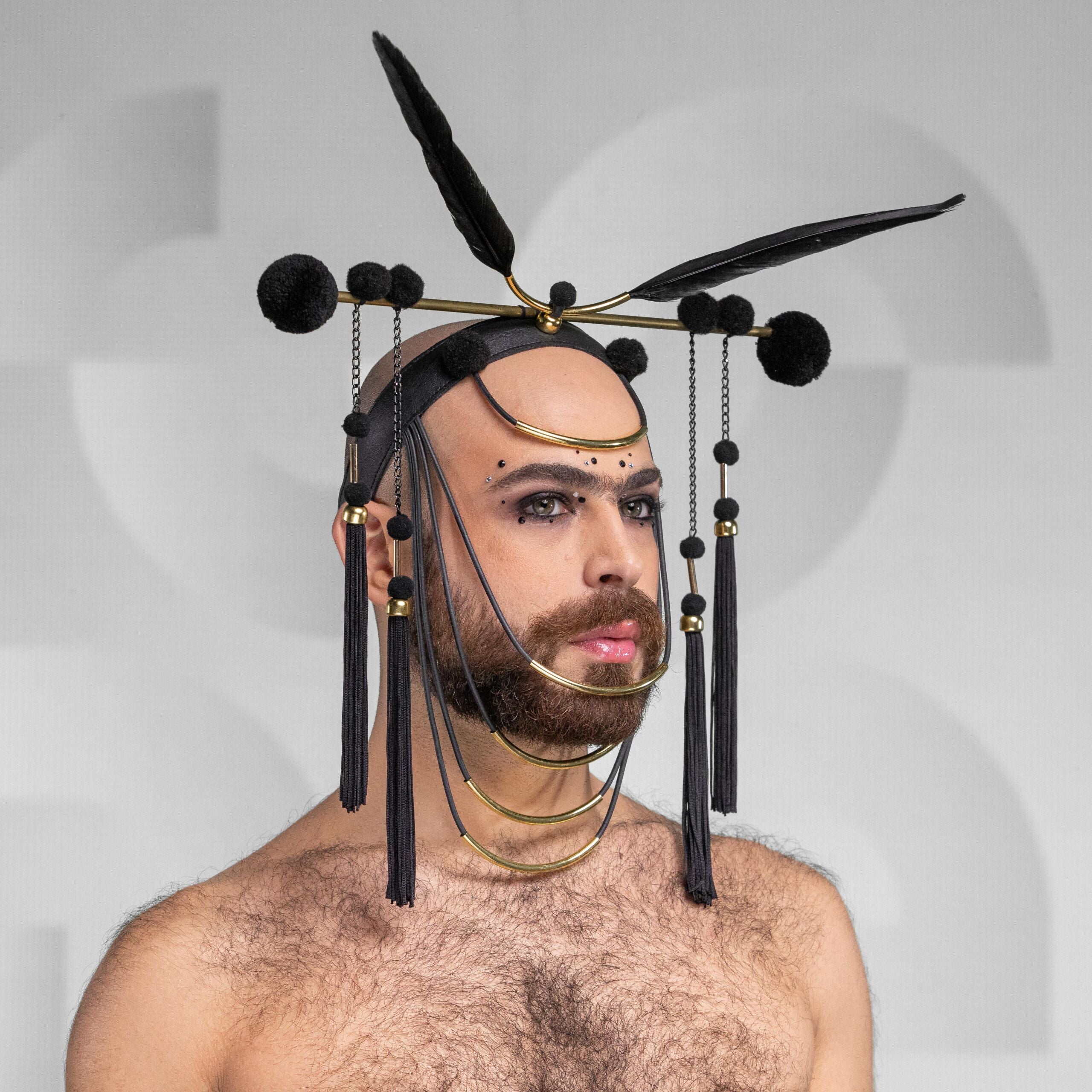 A mesmerizing headpiece, made from faux leather, feathers, PVC and brass.