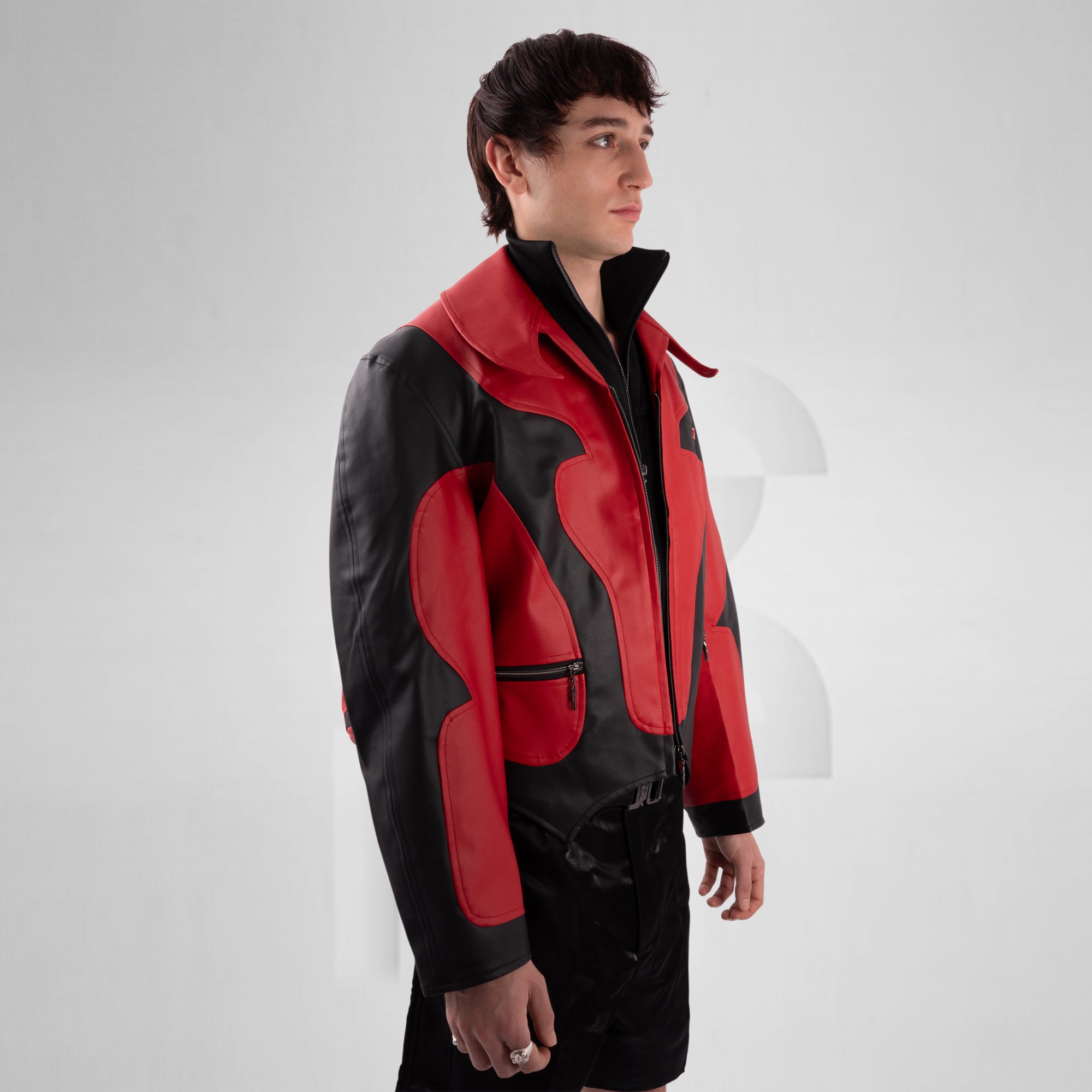 Person wearing a red and black jacket on a white background