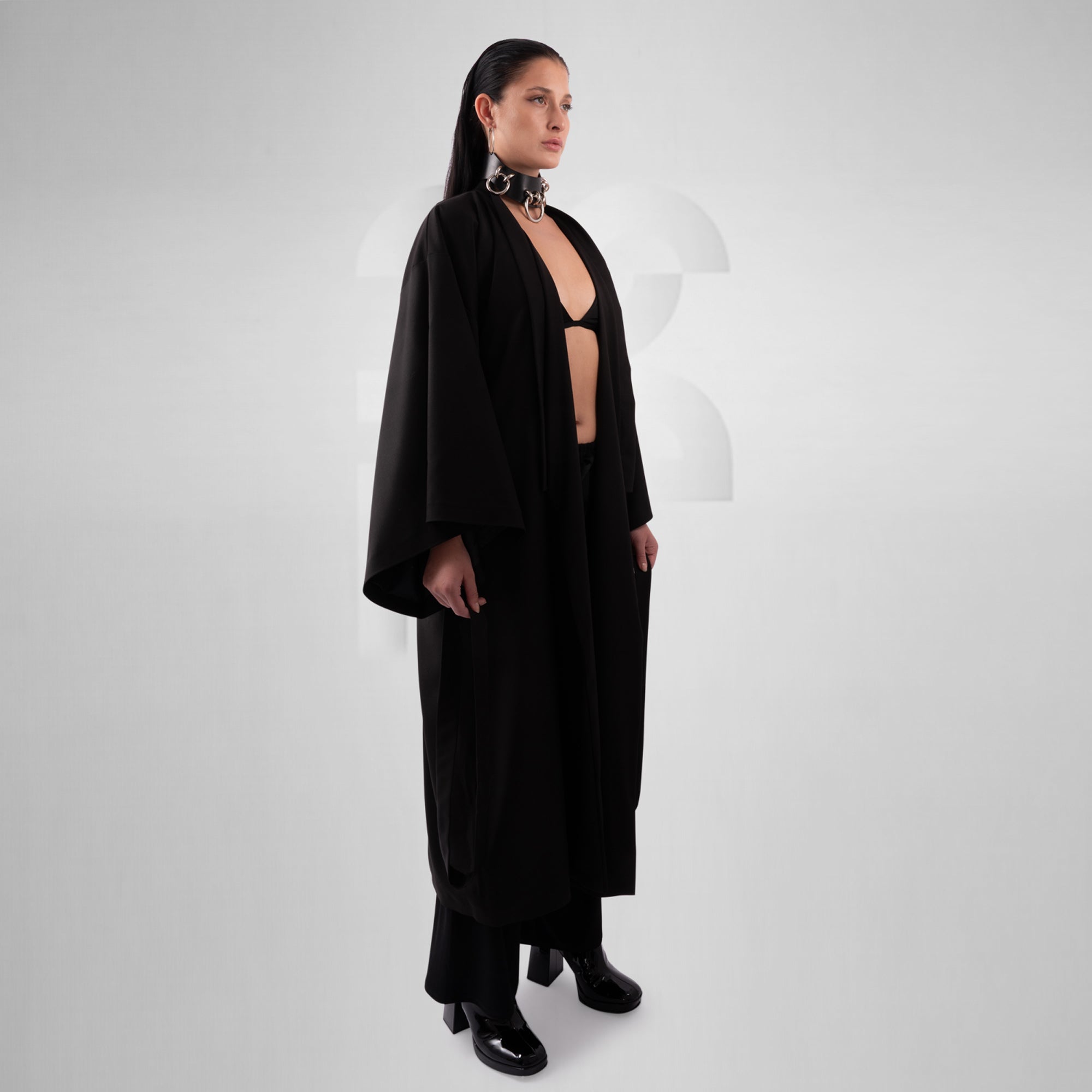 Woman wearing a black outfit on a white background