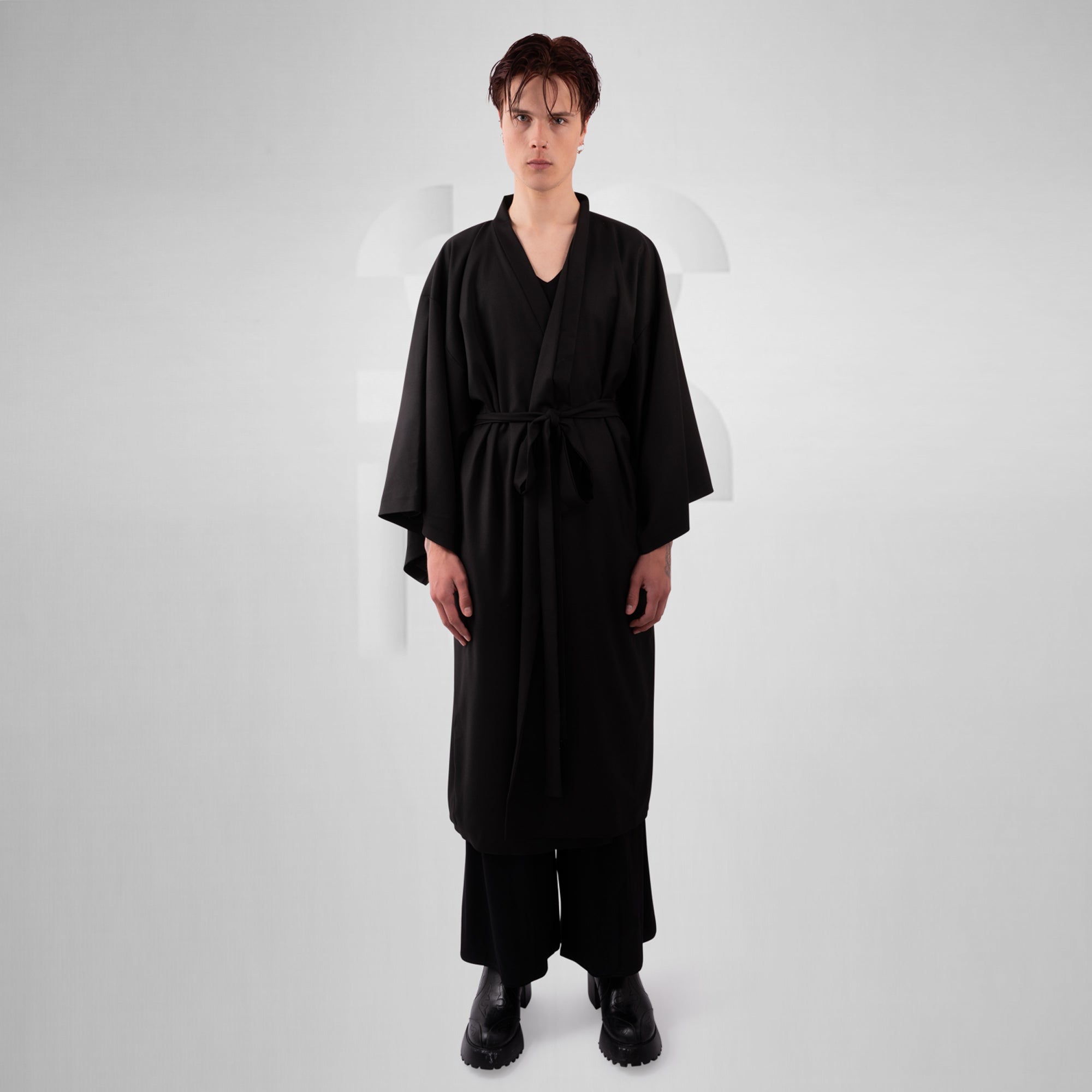 Person wearing a black robe on a white background