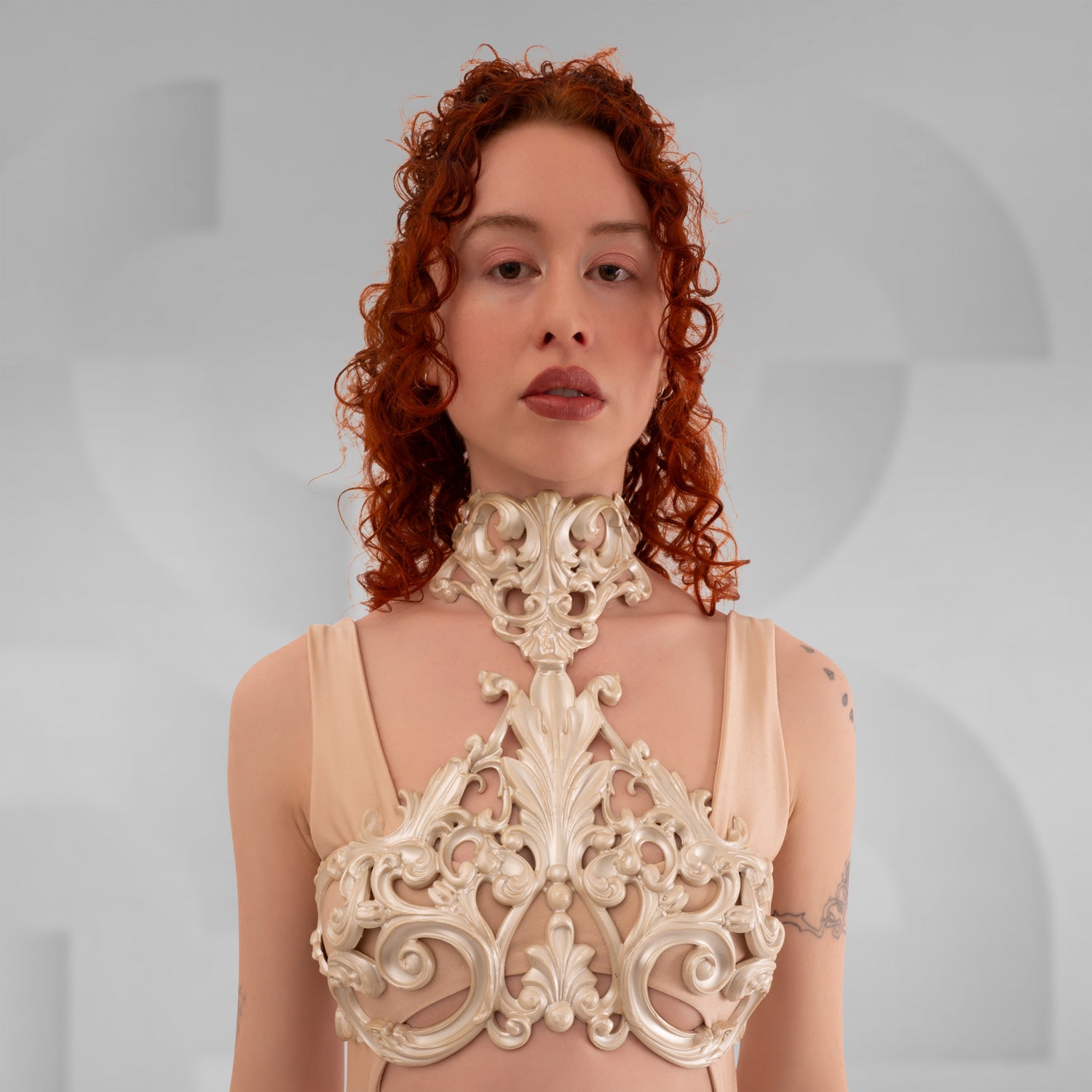 A model showcasing the Baroque 3D Latex Bra in Wine, demonstrating its elegant design against a light grey background. The bra's intricate 3D texture highlights its luxurious aesthetic, perfectly complementing the model's sophisticated look.