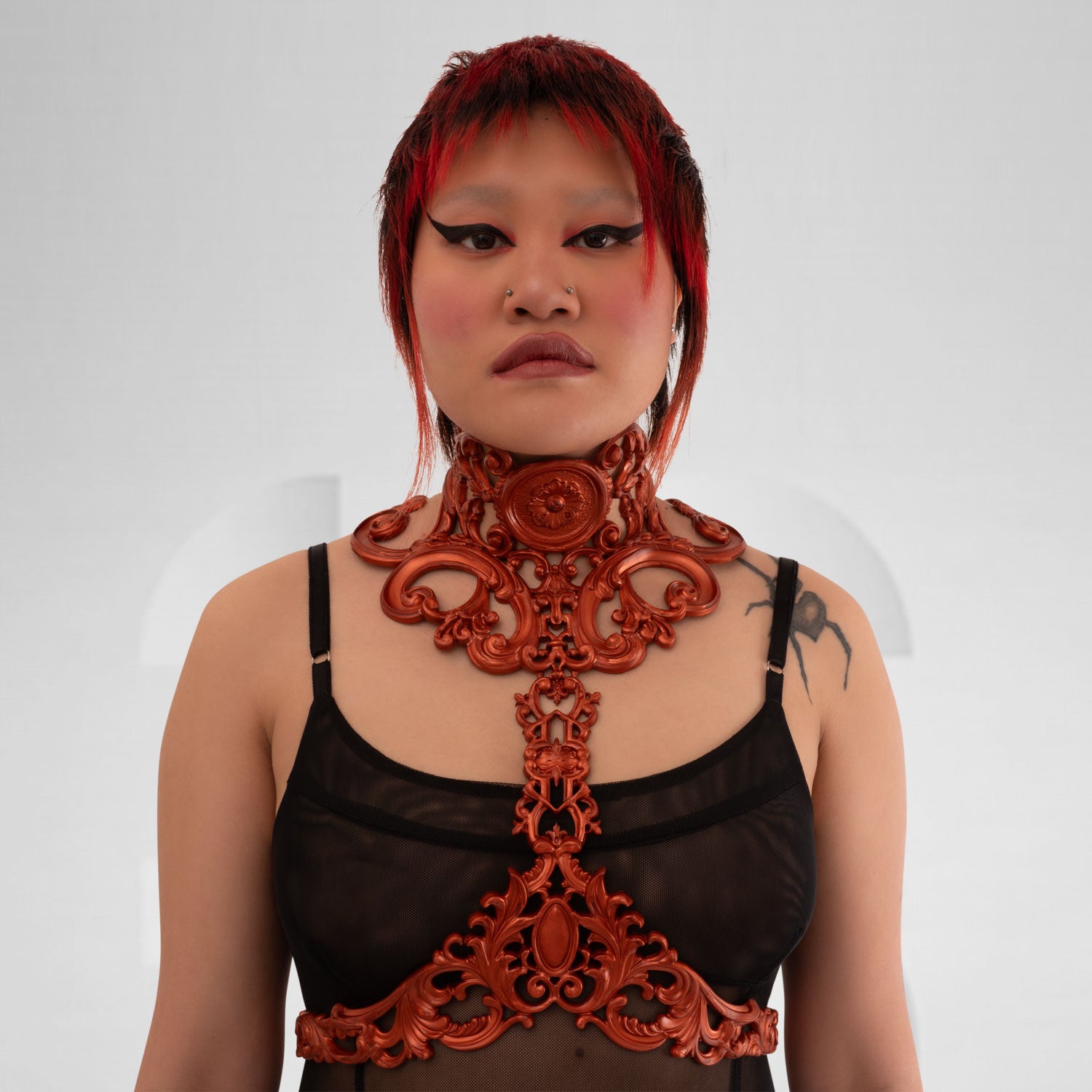 This image features a model wearing a stunning copper-colored harness with intricate baroque detailing. The harness elegantly frames the model's figure, combining artistic elements with a contemporary edge. Its bold design makes it an exceptional statement piece, ideal for avant-garde fashion enthusiasts. Perfect for nightlife or enhancing casual outfits, this harness exudes confidence and style.