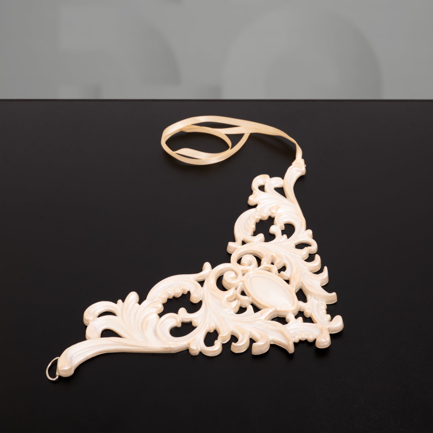 A pearl white 3D latex choker showcased on a black box, featuring the Code Berlin logo in the background."