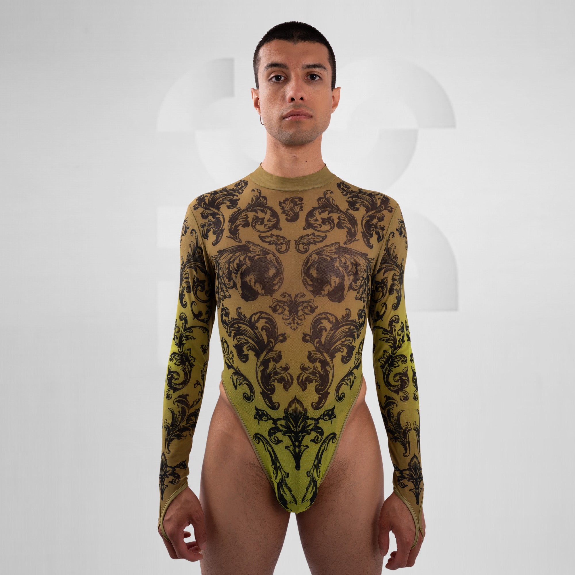 Man wearing a patterned green bodysuit on a white background