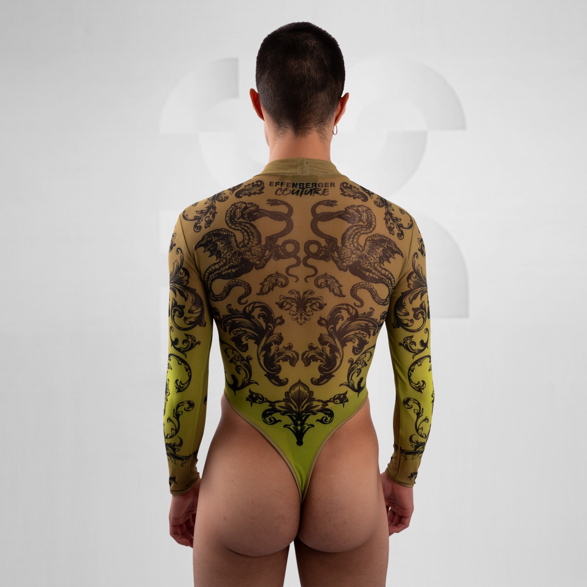 Person wearing a green and black patterned bodysuit on a white background