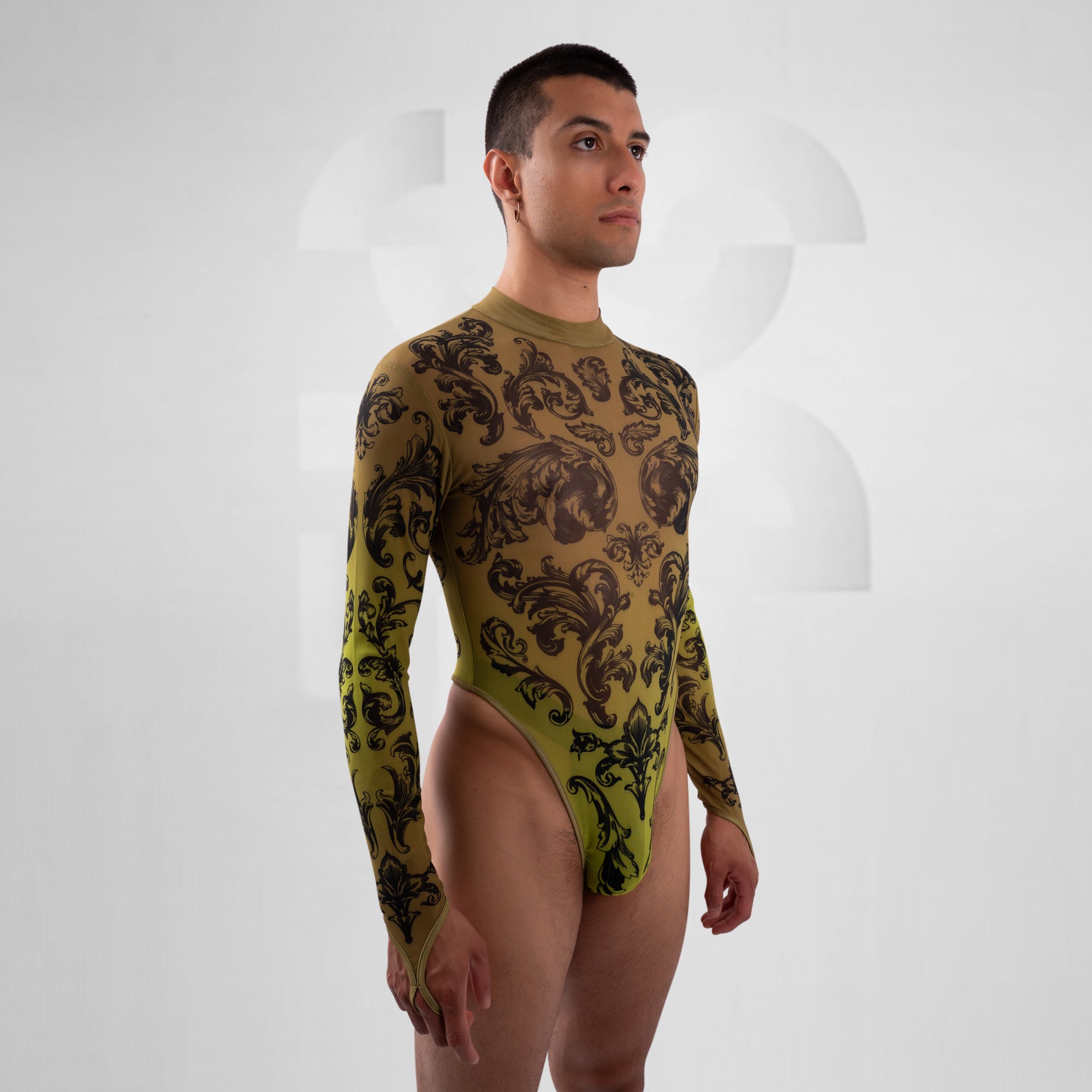 Man wearing a green and black patterned bodysuit on a white background