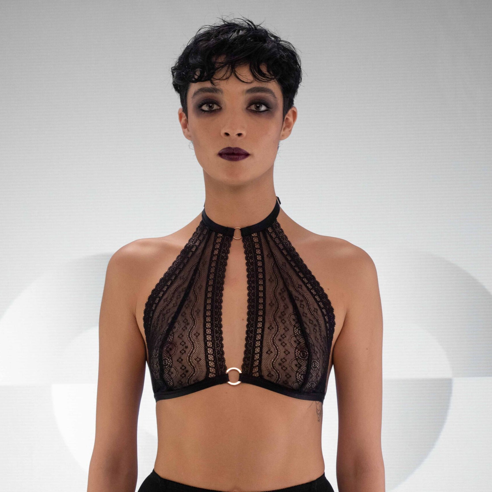 Playful black halter lace bralette with sophisticated ring details - your lingerie essential to embrace your unique elegance.