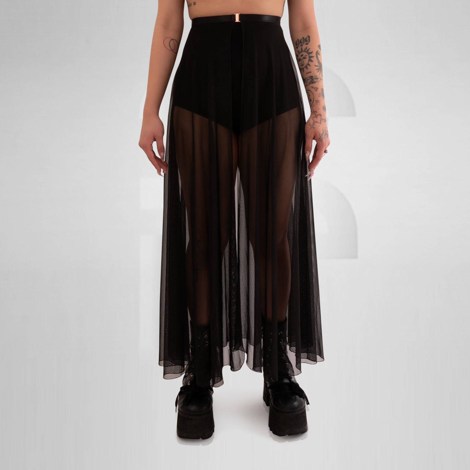 Long mesh skirt with front split and seductive appeal, creating a visually arresting piece that demands attention. Its long length gracefully flows down to the floor, providing a captivating and sophisticated look. The fabric embraces the wearer's curves, accentuating her feminine shape while remaining comfortable to wear.