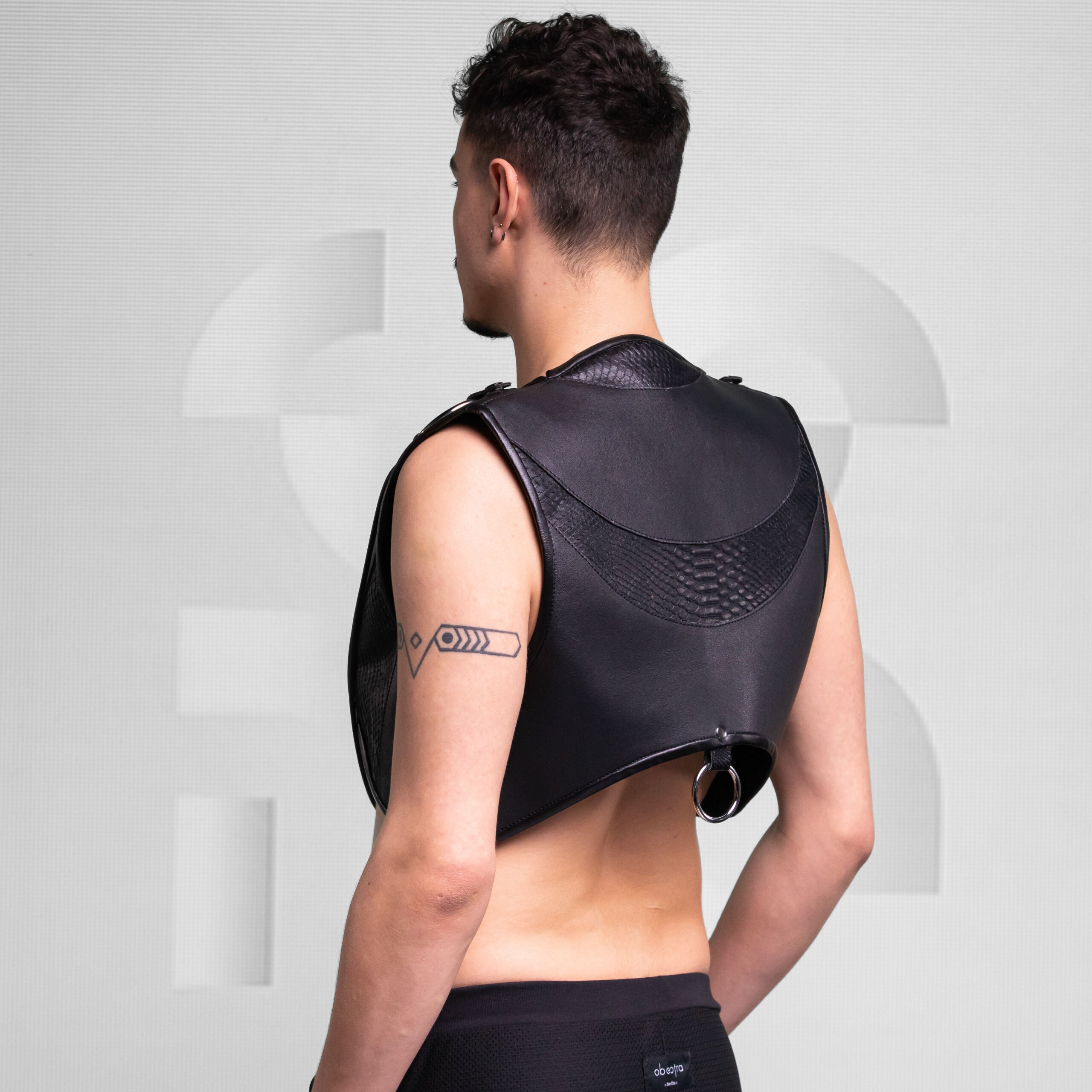 Enigmatic Harness Top with Ring Detail, made of vegan leather.