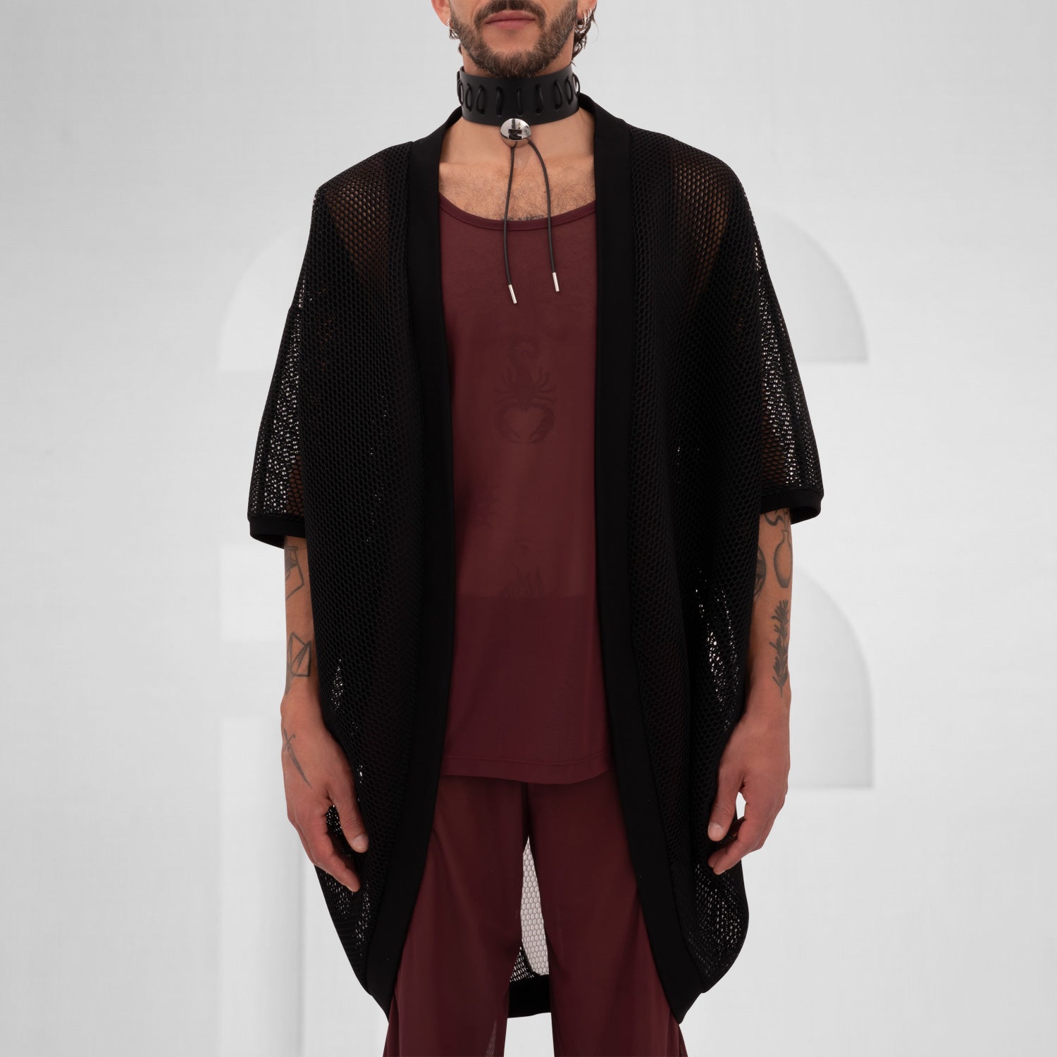 Black and white mesh cardigan with wide sleeves, designed for an edgy, modern look, reflecting the Berlin club scene aesthetic.