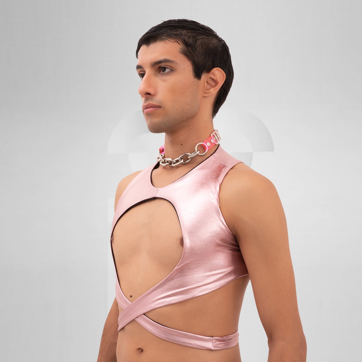 Introducing the Bound Gender-Neutral Foil Top from Berlin designer Nur Hektor. This avant-garde piece features eye-catching foil accents and a bold, wraparound design, making it ideal for festivals and clubwear. Perfect for expressing individuality and embracing a kinky, edgy style, this top captures the essence of Berlin's cutting-edge fashion. Elevate your look and stand out with this unique statement piece!