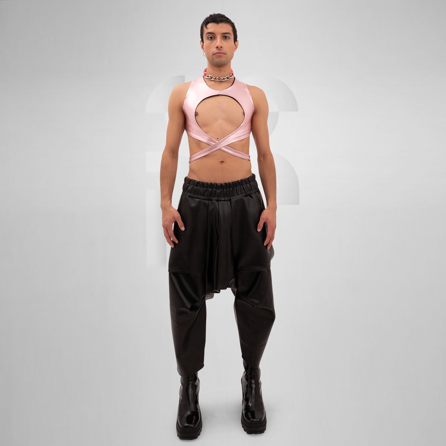 Introducing the Bound Gender-Neutral Foil Top from Berlin designer Nur Hektor. This avant-garde piece features eye-catching foil accents and a bold, wraparound design, making it ideal for festivals and clubwear. Perfect for expressing individuality and embracing a kinky, edgy style, this top captures the essence of Berlin's cutting-edge fashion. Elevate your look and stand out with this unique statement piece!