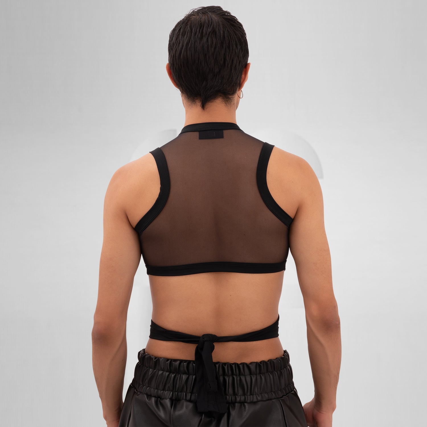 Introducing the Bound Gender-Neutral Mesh Top from Berlin designer Nur Hektor. This avant-garde piece combines sheer mesh with a daring wraparound design, making it perfect for festivals and clubwear. The striking cut-out detail offers a bold yet stylish silhouette, allowing for expressive individuality and a unique fashion statement.