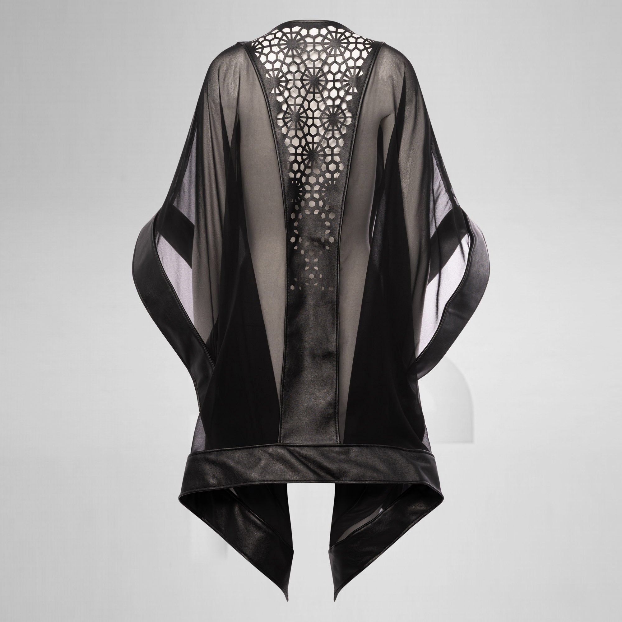 Black sheer jacket with intricate back design on a gray background