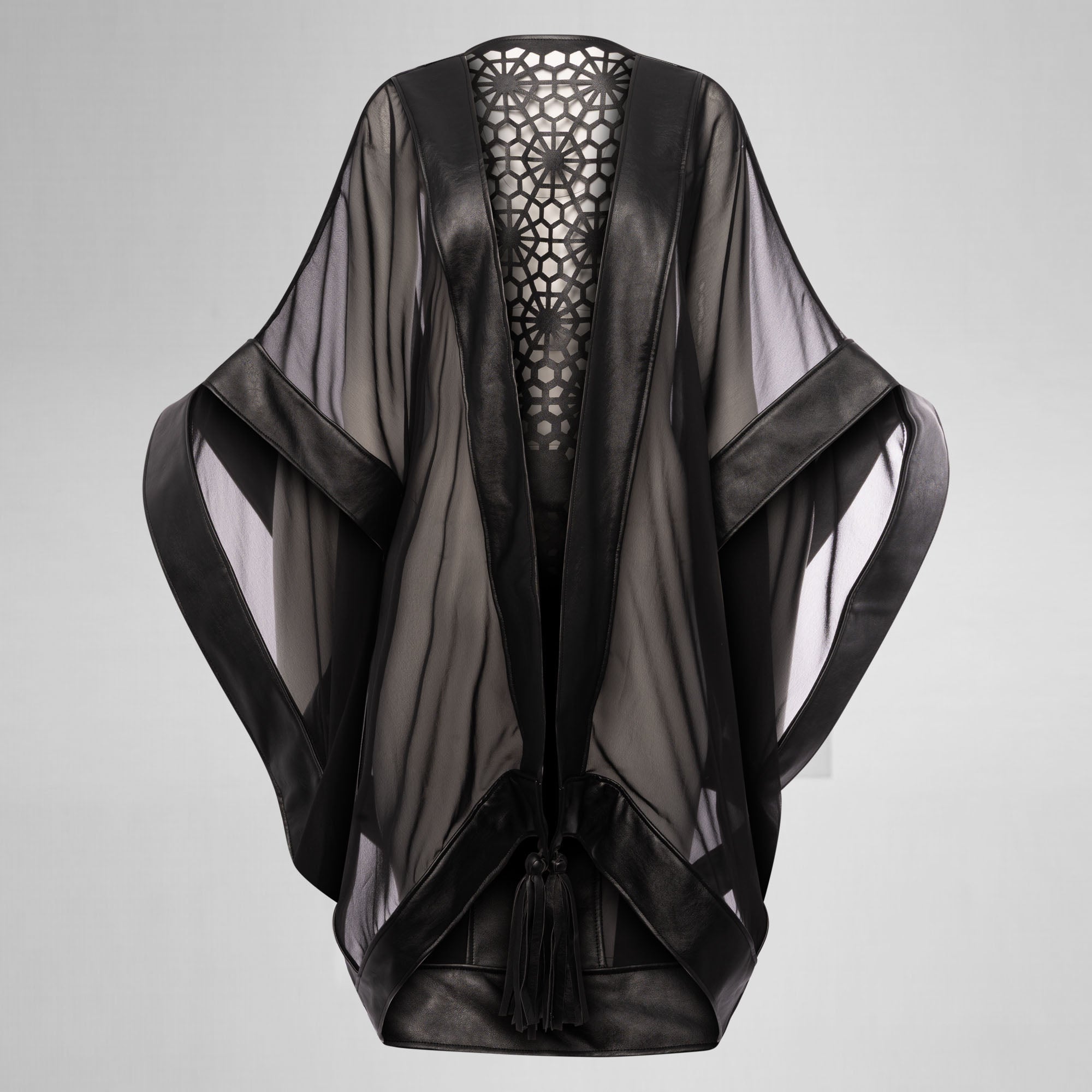 Sheer black jacket with cut-out back design on a gray background