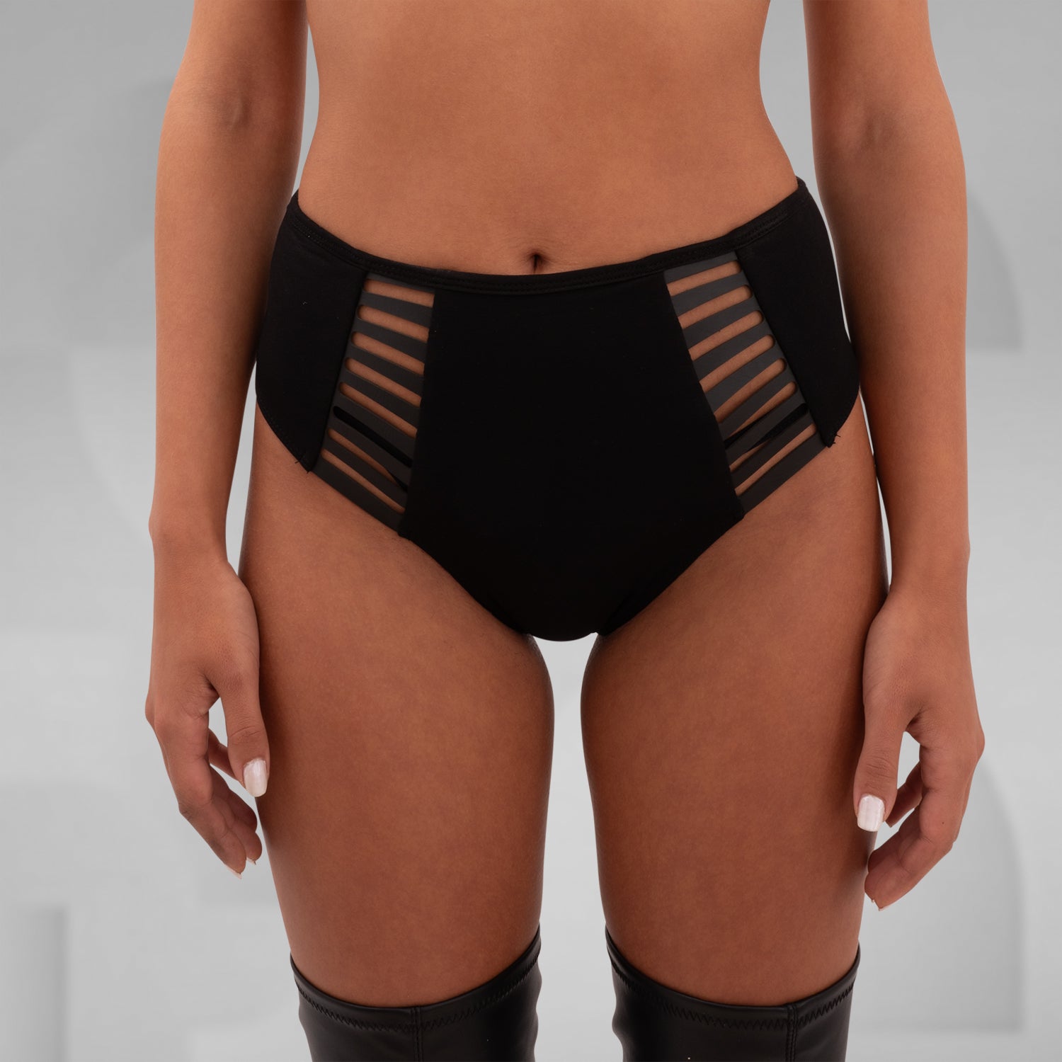 These High-Waisted Strappy Briefs from Cyberesque blend bold design with comfort and style. Featuring sleek strappy details on the sides, they add an edgy touch to your wardrobe. Perfect for pairing with your favorite festival or clubwear pieces, these briefs offer a seamless fit that embraces your curves. Ideal for those who love to make a statement, they bring a modern, avant-garde flair to any ensemble.