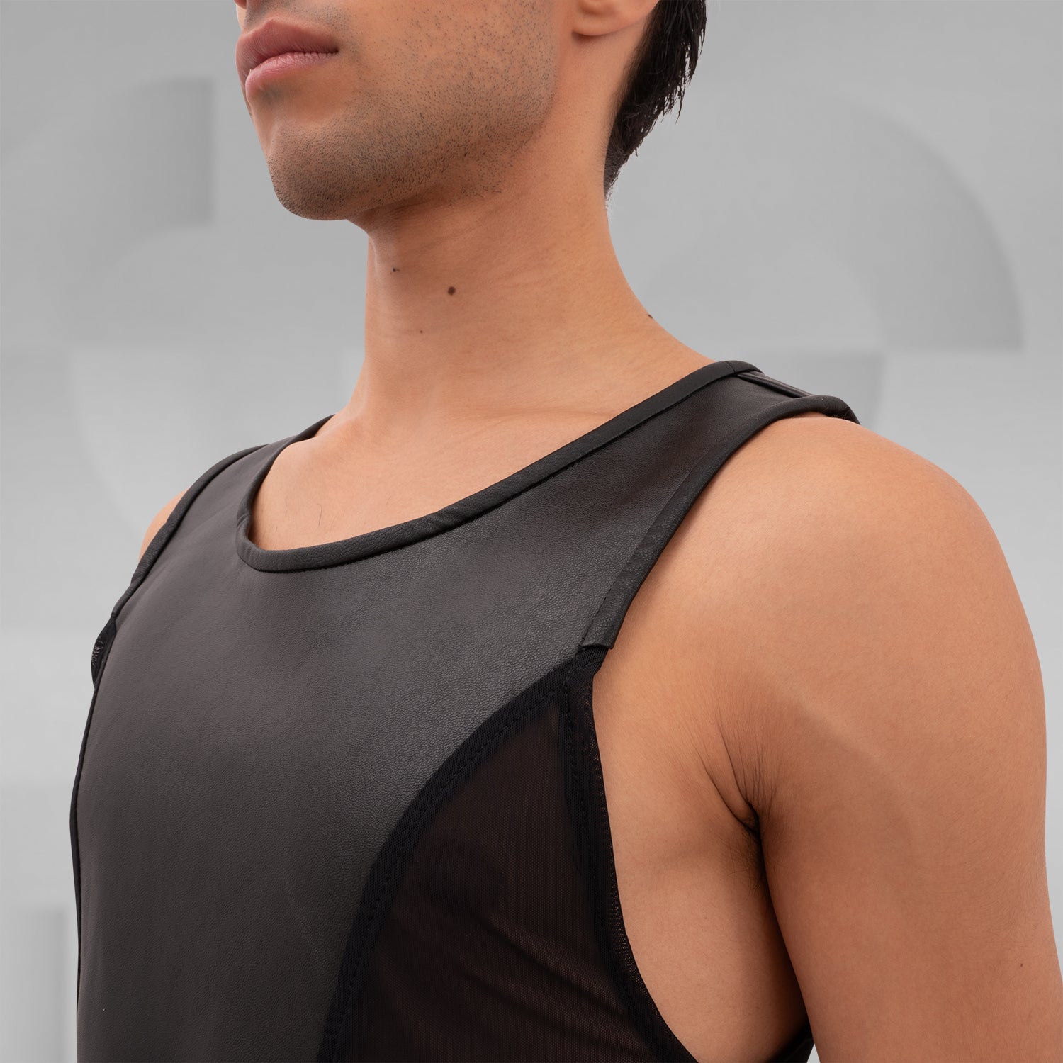 Cutting_Edge_Faux_Leather_Mesh_Tanktotop from Cyberesque blends sleek vegan leather with mesh panels for a dynamic look. This tank top offers a modern, edgy style perfect for tribal festivals or avant-garde street fashion. Its minimalist design exudes sophistication, making it an ideal choice for anyone looking to make a bold statement. Wear it to showcase your unique fashion sense with confidence.
