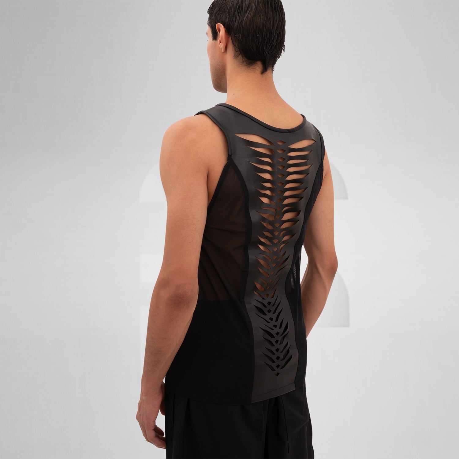 The Cutting Edge Vegan Leather Mesh Tanktop from Cyberesque blends sleek vegan leather with mesh panels for a dynamic look. This tank top offers a modern, edgy style perfect for tribal festivals or avant-garde street fashion. Its minimalist design exudes sophistication, making it an ideal choice for anyone looking to make a bold statement. Wear it to showcase your unique fashion sense with confidence.