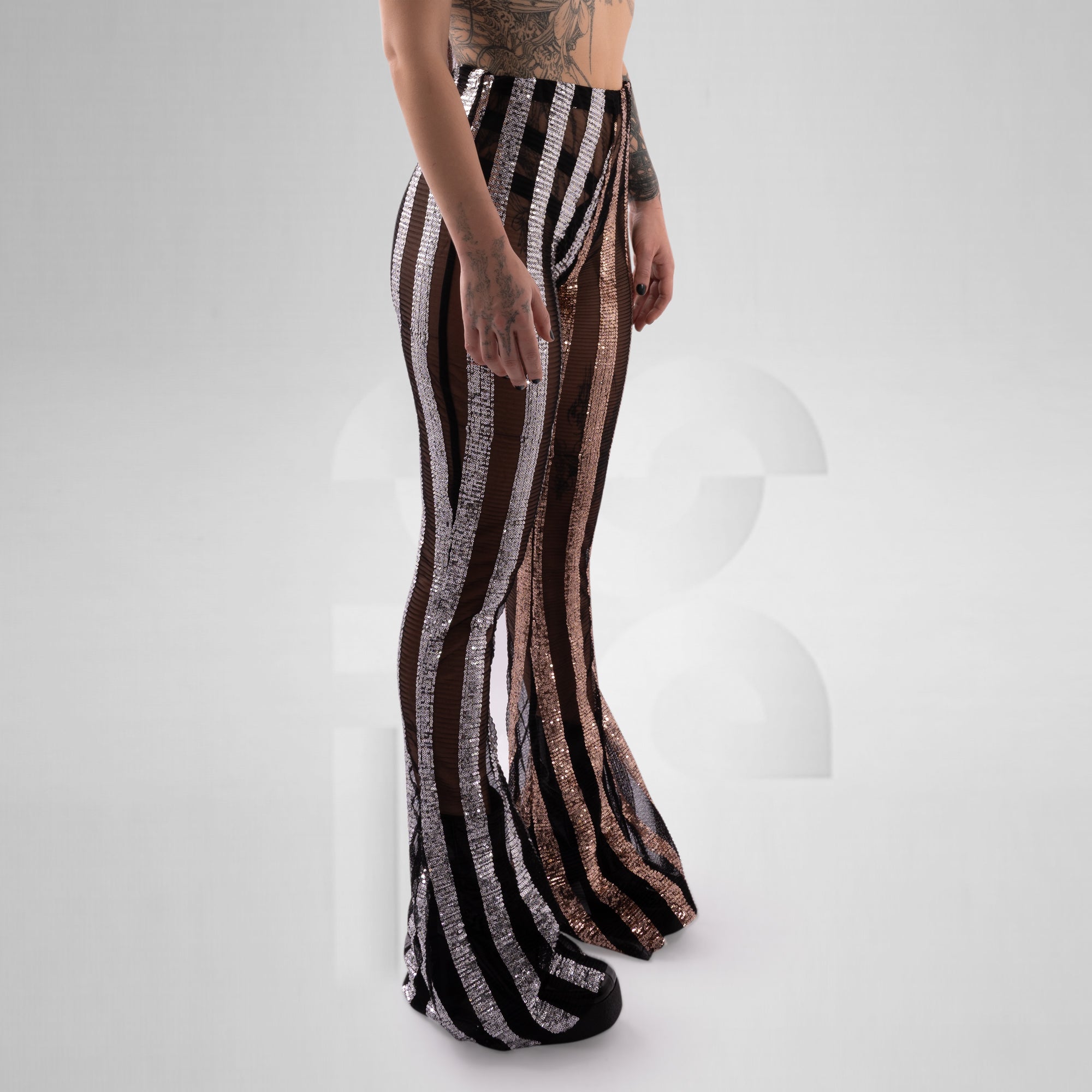 Striped pants worn by a person on a white background