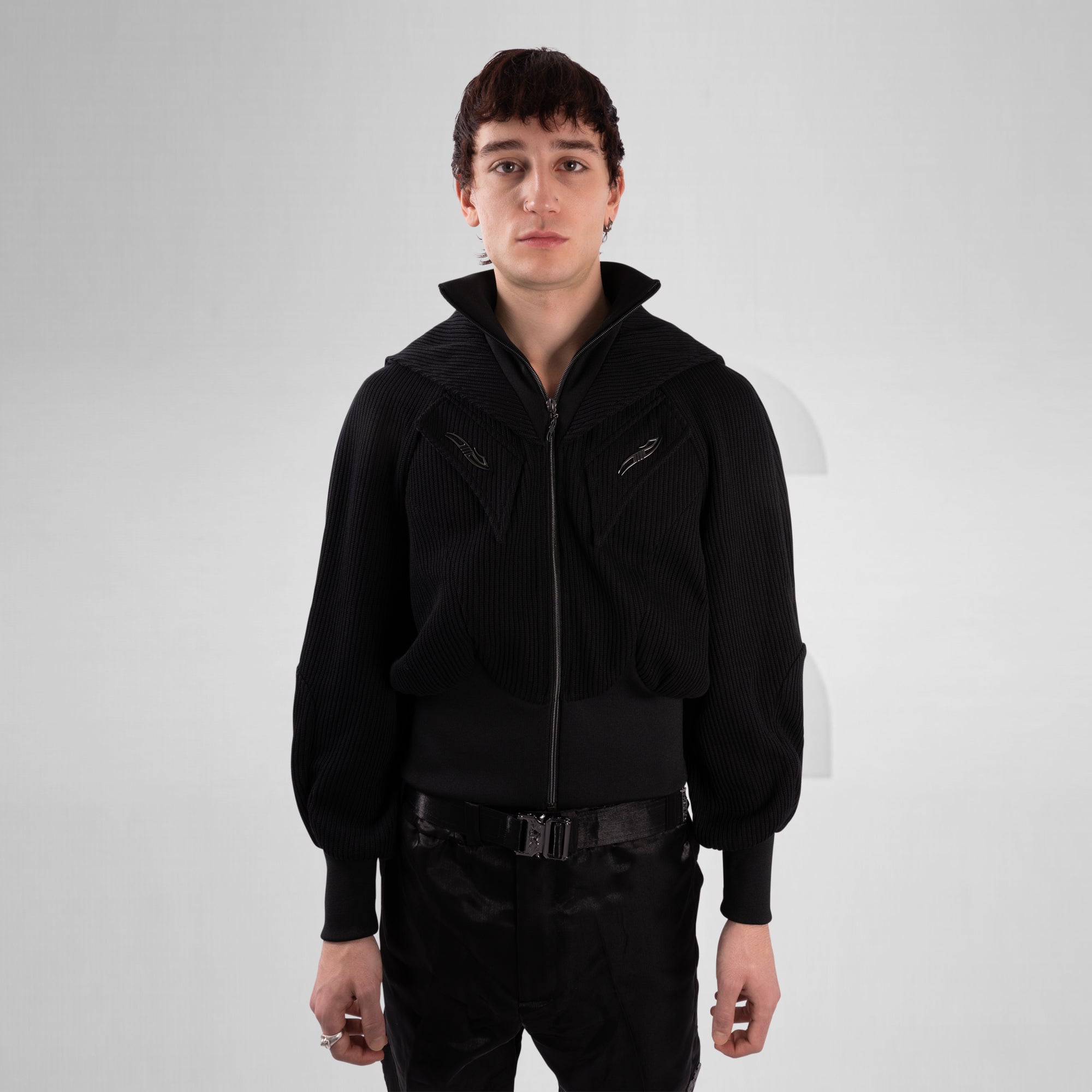 Person wearing a black jacket on a white background