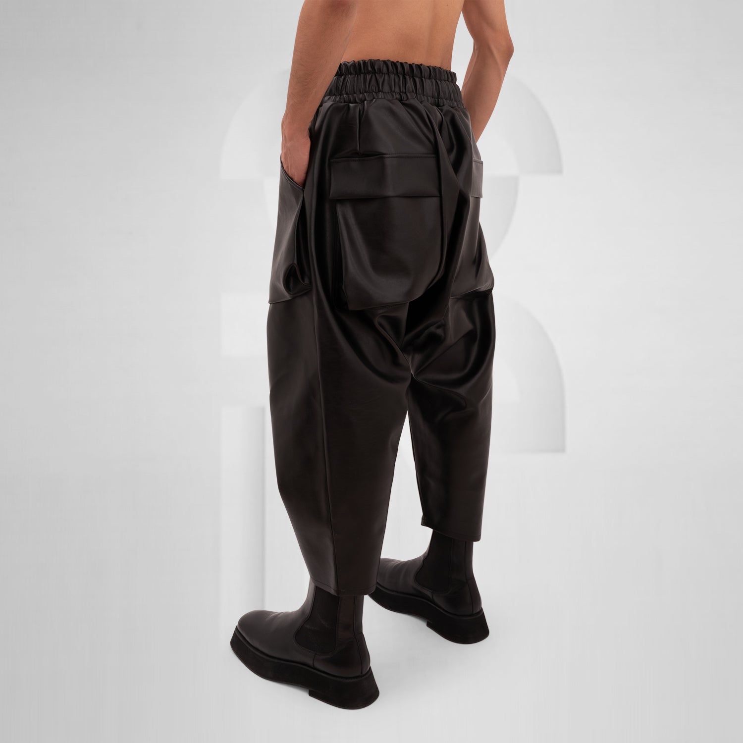 The Faux Leather Balloon Trousers from This is Fred feature a bold and modern silhouette that redefines contemporary style. Crafted from faux leather, these trousers combine luxury with sustainability, making them a standout addition to any wardrobe. The unique balloon shape allows for freedom of movement while adding an avant-garde touch to your look.