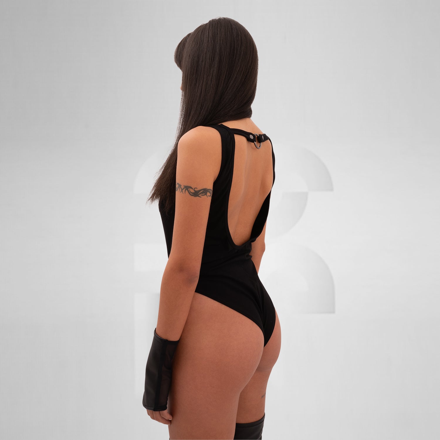 faux leather, and elastane, featuring bold straps, sleek design, and discreet snap closures.