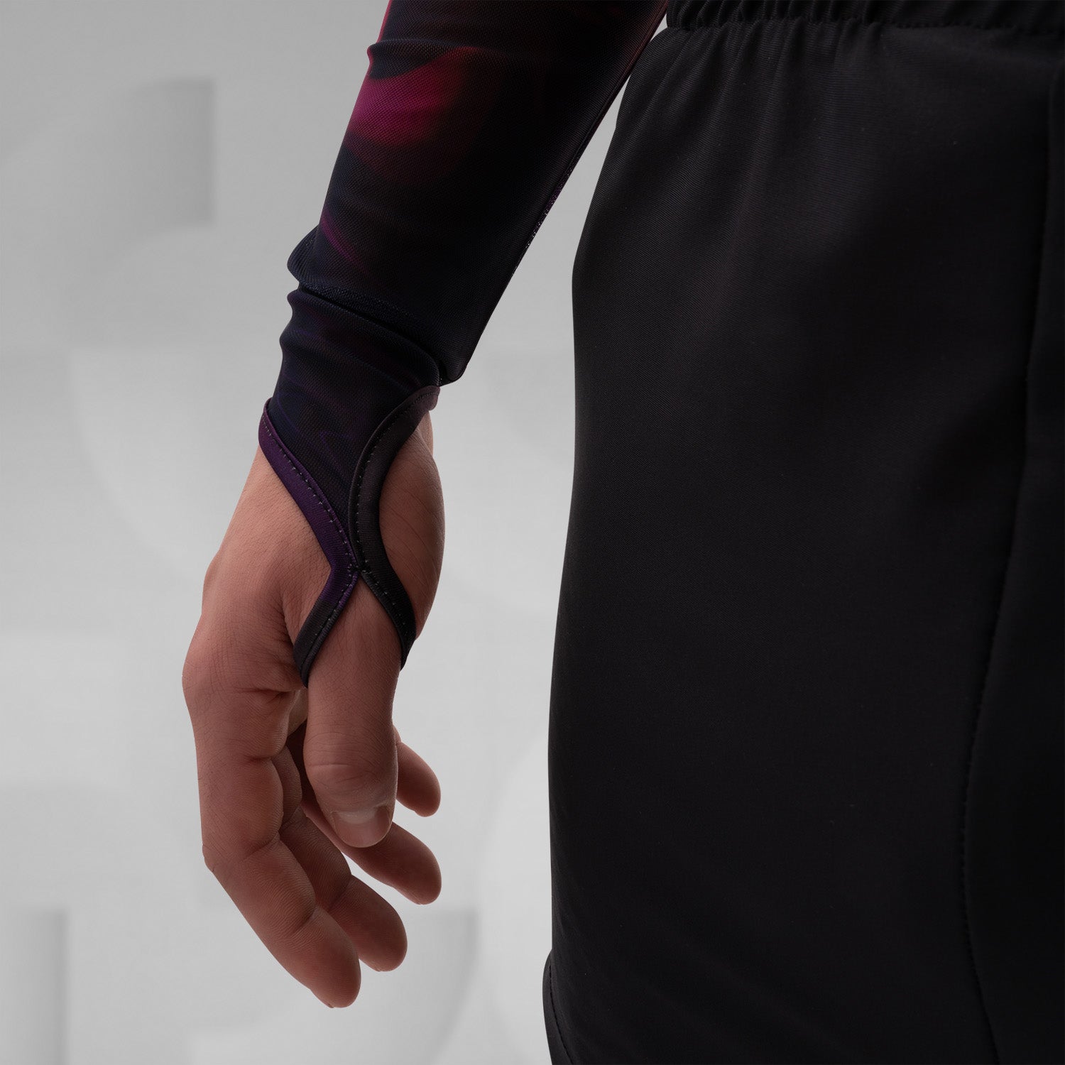The image features a striking outfit showcasing a long-sleeve top with a captivating abstract design in rich hues of red and purple. Its unique metallic neck detail adds an edgy touch, perfectly complementing the bold, artistic style. The top is paired with eye-catching shorts featuring reflective panels, creating a dynamic look that's perfect for standing out. This ensemble is ideal for nightlife events or fashion-forward gatherings, exuding confidence and individuality while embracing a modern aesthetic.