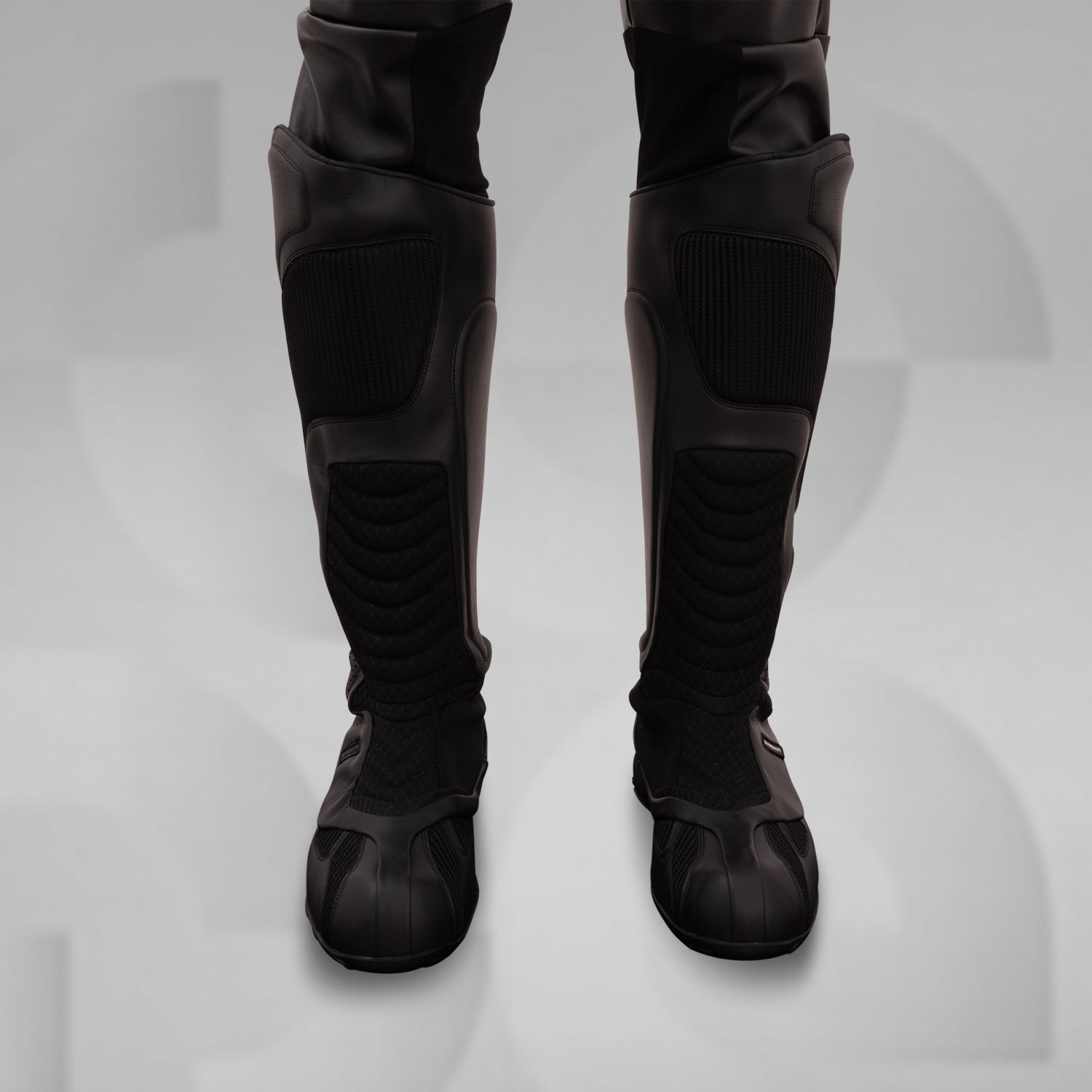The image features sleek, futuristic black boots with a high, protective design. These avant-garde boots boast textured panels and reinforced sections, combining style and functionality. Ideal for fashion-forward individuals, they offer both comfort and edgy aesthetics, making them perfect for urban adventures or making a statement in any environment.