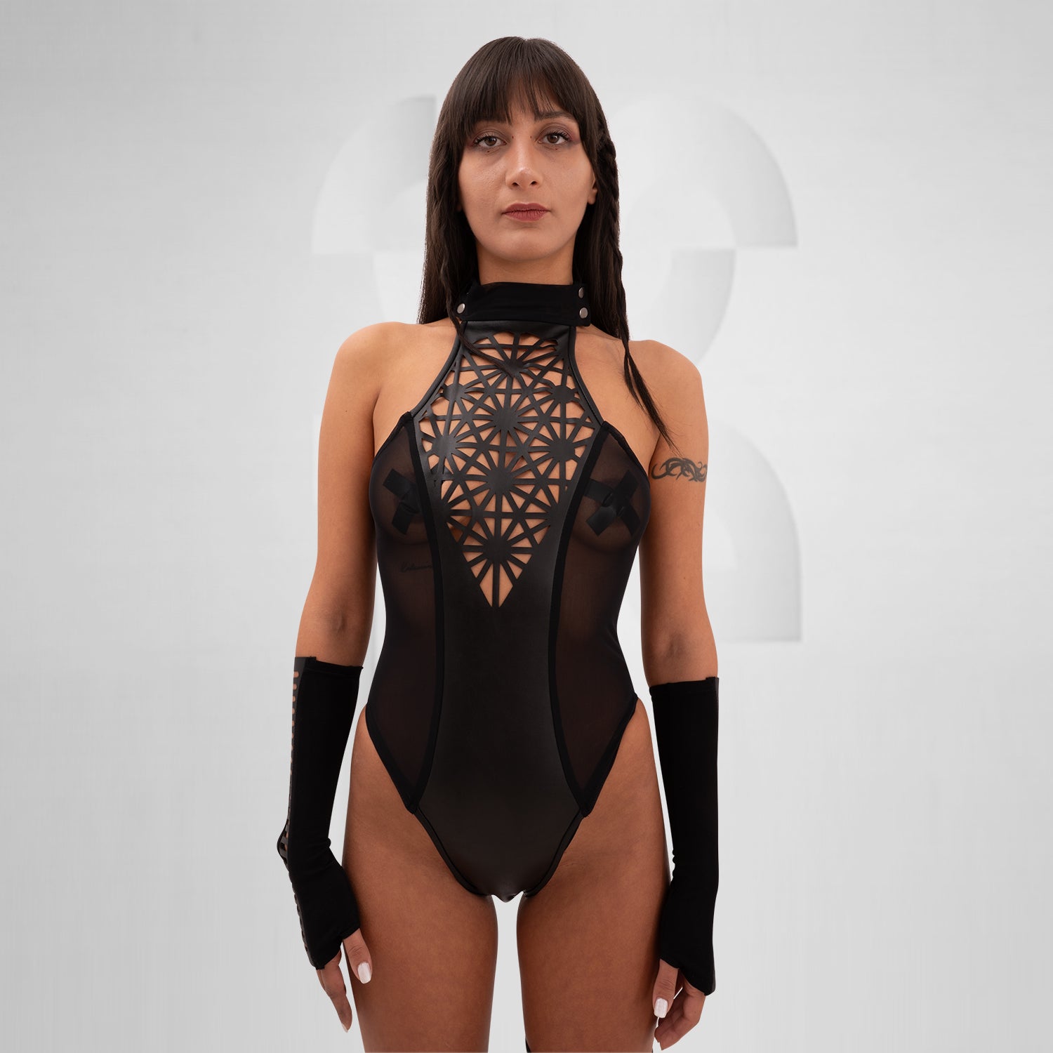 The Printed Sheer Bodysuit from Cyberesque is a striking combination of elegance and bold design. Featuring intricate laser-cut patterns that create a stunning visual impact, this bodysuit perfectly balances allure with avant-garde aesthetics. The sheer fabric elegantly hugs your curves, making it ideal for festivals, clubwear, or glamorous nights out. Complete with stylish long sleeves, this piece elevates your look, allowing you to express your unique style with confidence.