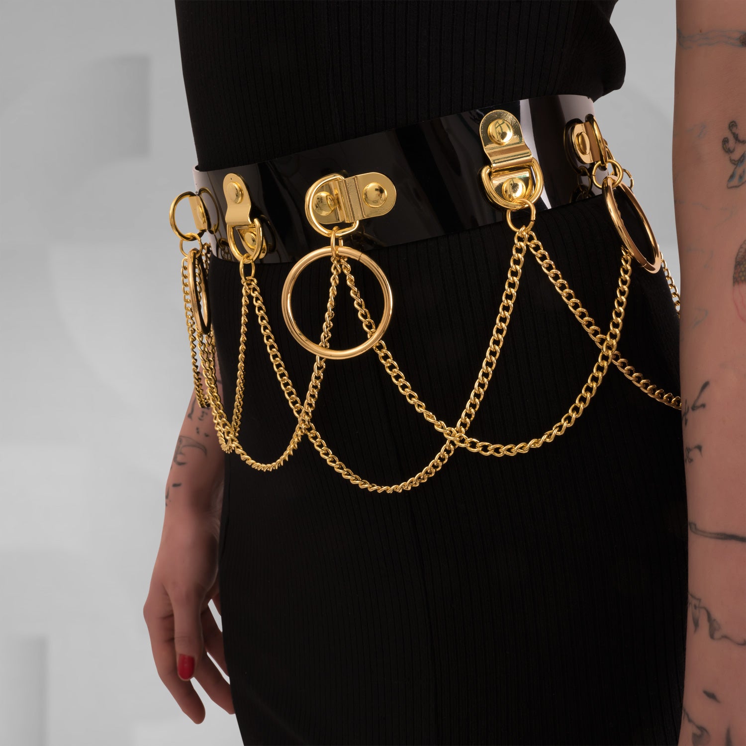 he Kinky Full Body Set in Black PVC from Miss Overdose, featuring a high-gloss finish and silver rings. This harness-style outfit is designed for edgy looks, perfect for kinky parties and club nights, adding a striking touch to any ensemble.