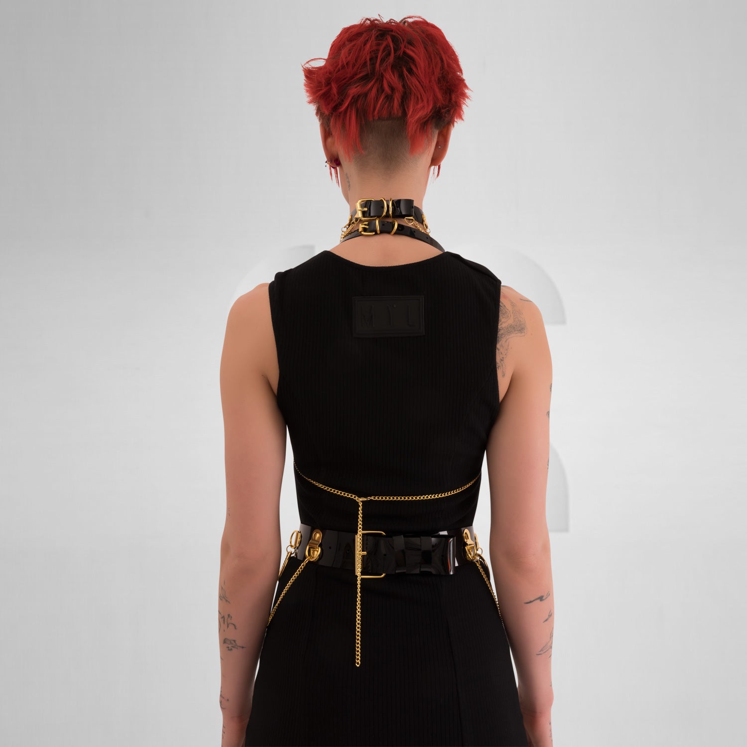 he Kinky Full Body Set in Black PVC from Miss Overdose, featuring a high-gloss finish and silver rings. This harness-style outfit is designed for edgy looks, perfect for kinky parties and club nights, adding a striking touch to any ensemble.