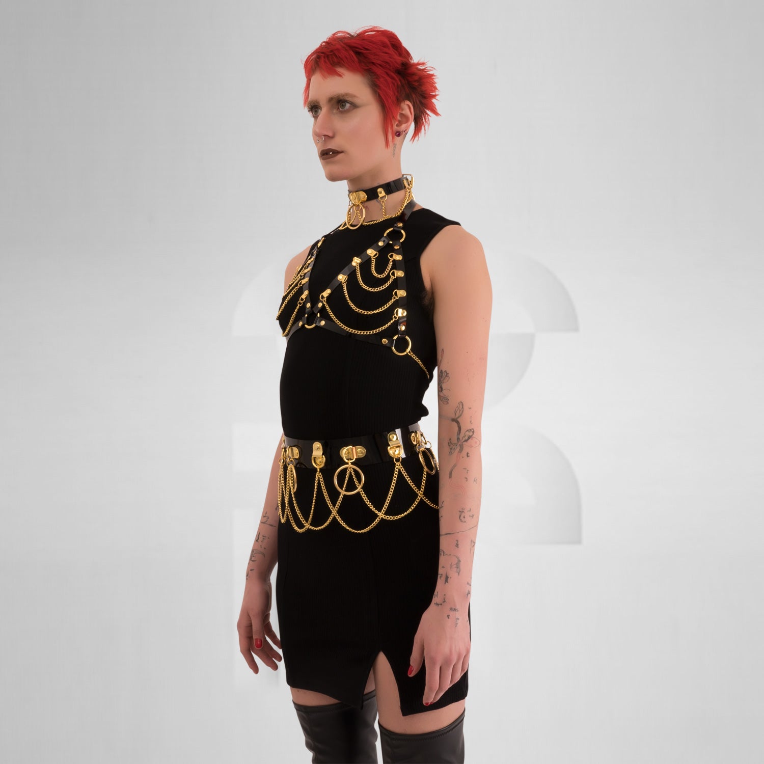 he Kinky Full Body Set in Black PVC from Miss Overdose, featuring a high-gloss finish and silver rings. This harness-style outfit is designed for edgy looks, perfect for kinky parties and club nights, adding a striking touch to any ensemble.