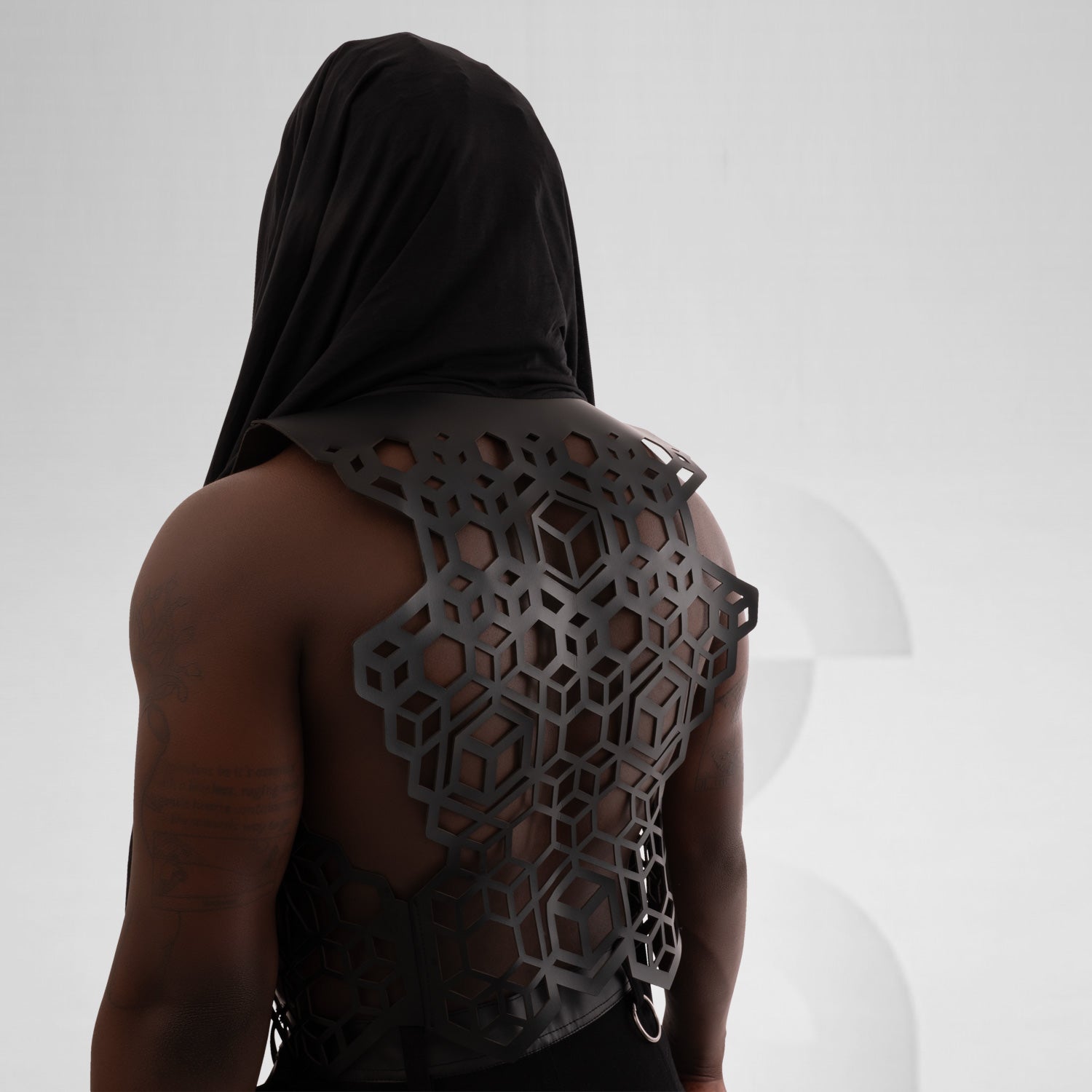 This Berlin festival-inspired ensemble features a faux leather vest with laser cut back details and a trendy jersey hoodie.