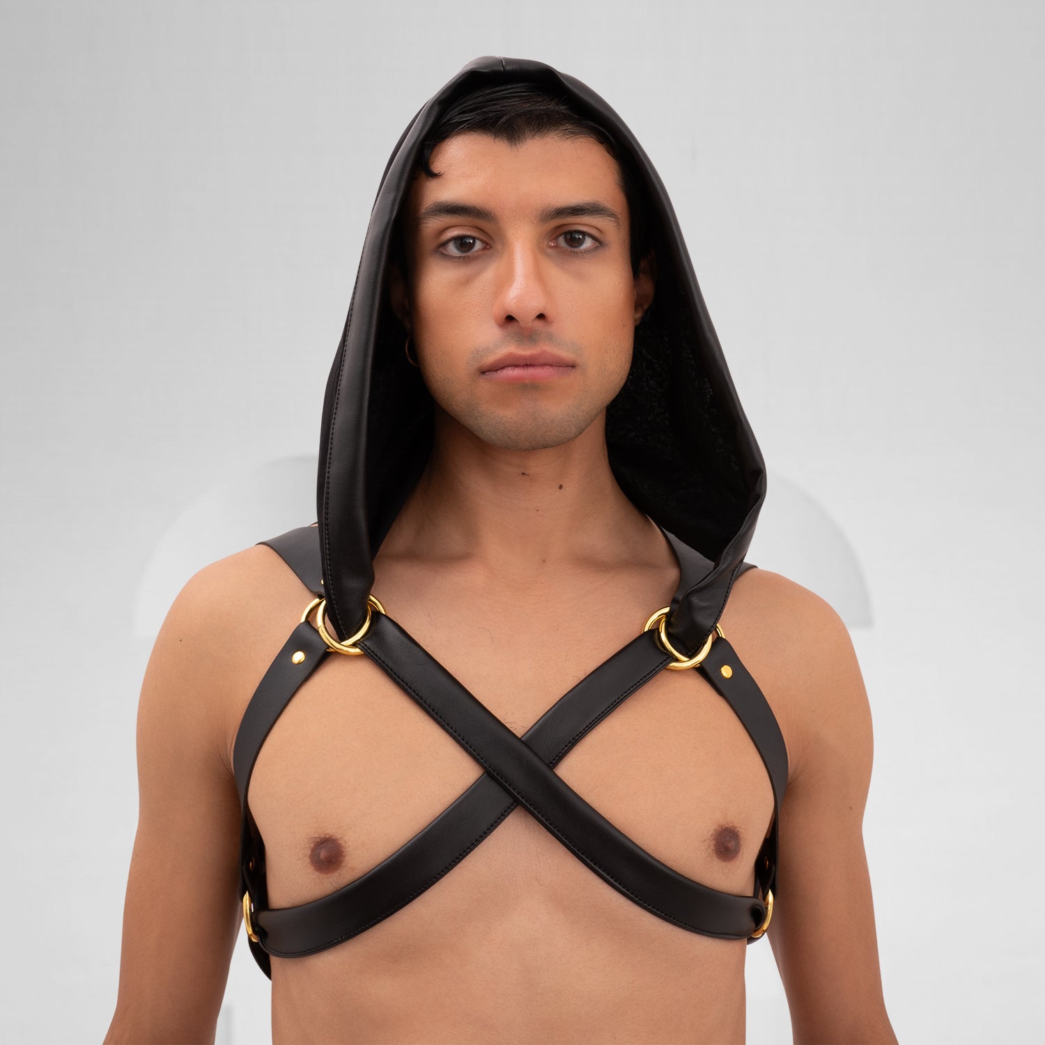 The Laser Cut Harness with Hood from Cyberesque is a striking fusion of avant-garde design and innovative clubwear. Featuring eye-catching laser-cut details on the back, this harness delivers a bold visual impact that is sure to make a statement. The adjustable straps ensure a perfect fit, allowing for both comfort and style as you navigate the nightlife scene. Paired with sleek trousers, this ensemble exudes modernity and confidence, making it ideal for fashion-forward individuals who are unafraid to embra