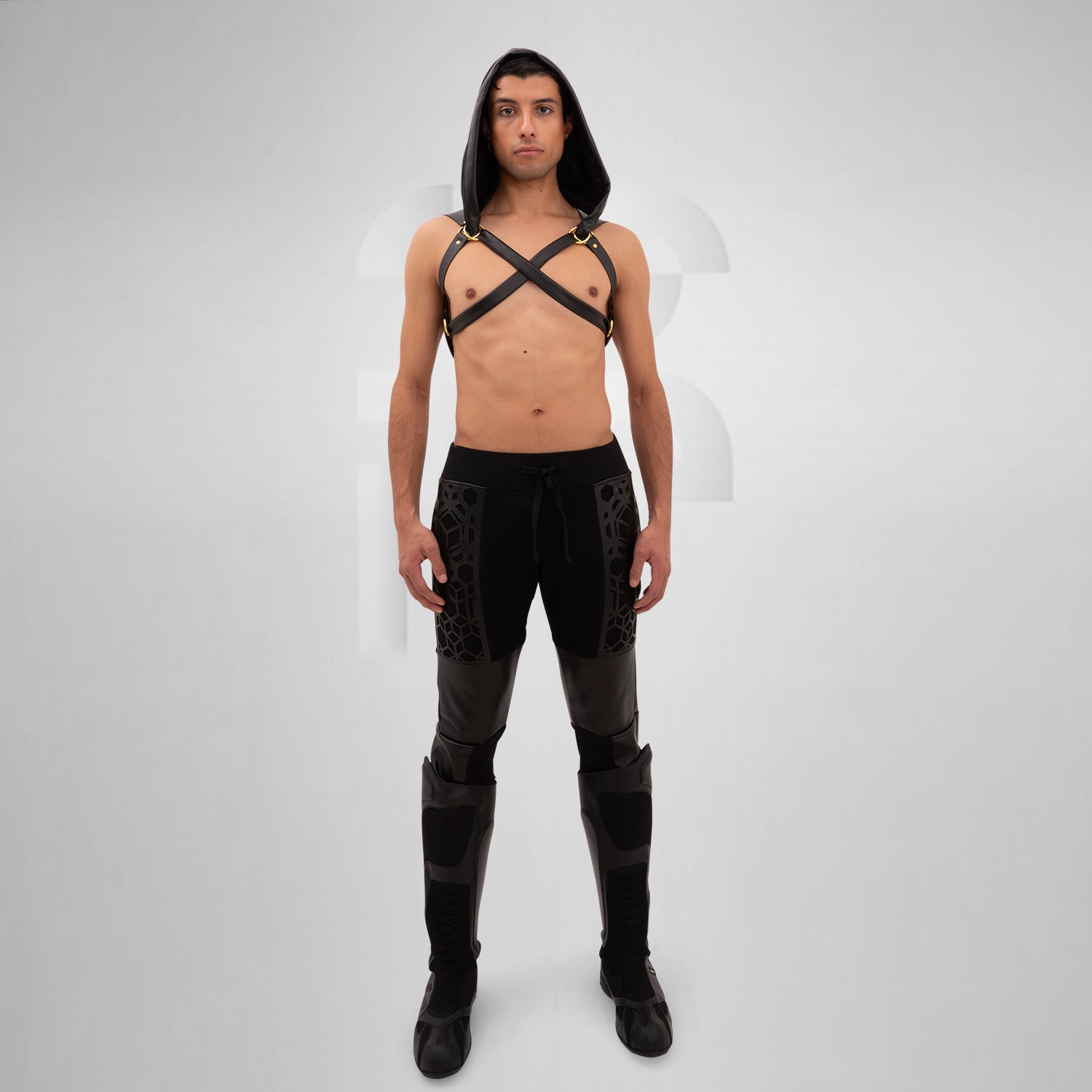 The Laser Cut Harness with Hood from Cyberesque is a striking fusion of avant-garde design and innovative clubwear. Featuring eye-catching laser-cut details on the back, this harness delivers a bold visual impact that is sure to make a statement. The adjustable straps ensure a perfect fit, allowing for both comfort and style as you navigate the nightlife scene. Paired with sleek trousers, this ensemble exudes modernity and confidence, making it ideal for fashion-forward individuals who are unafraid to embra