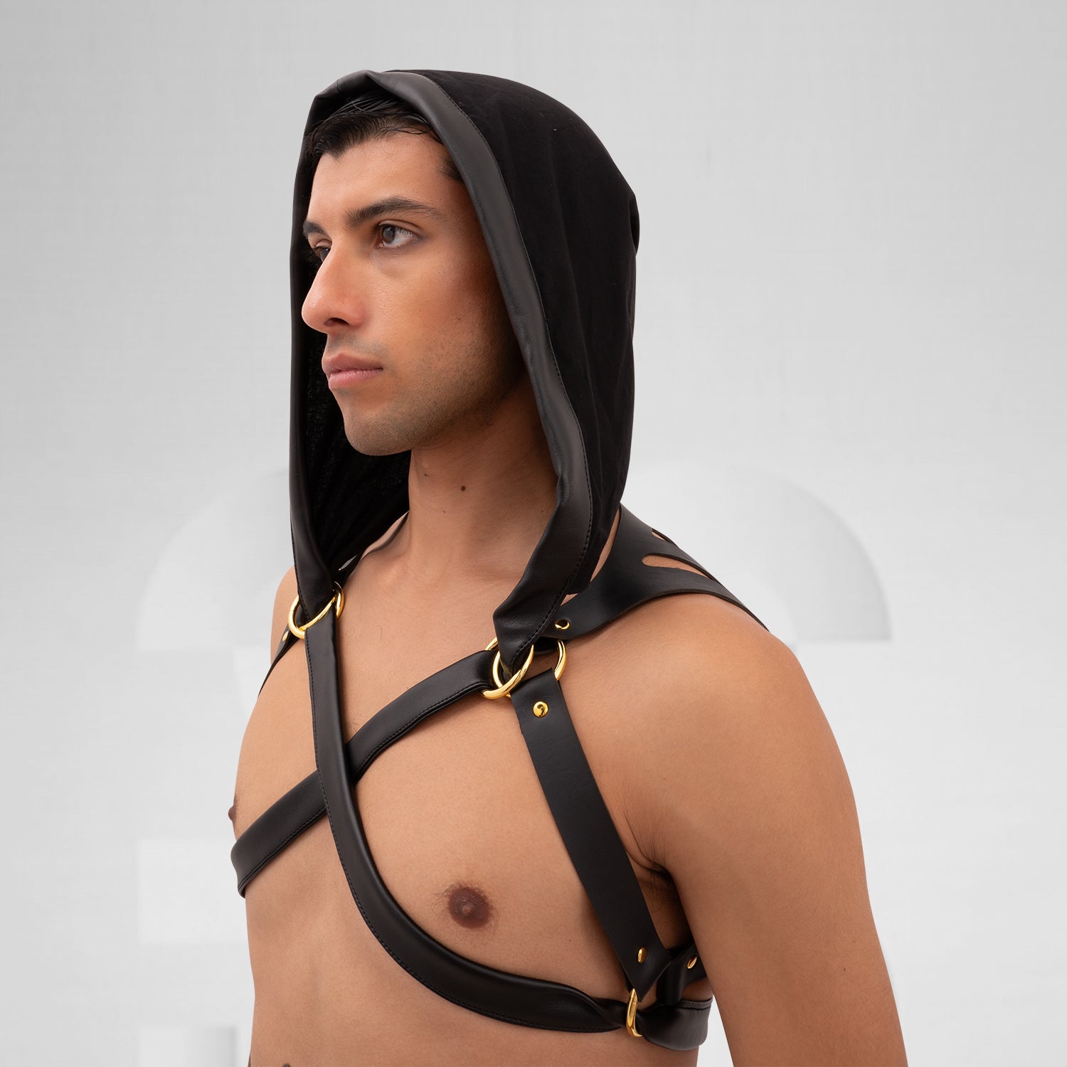 The Laser Cut Harness with Hood from Cyberesque is a striking fusion of avant-garde design and innovative clubwear. Featuring eye-catching laser-cut details on the back, this harness delivers a bold visual impact that is sure to make a statement. The adjustable straps ensure a perfect fit, allowing for both comfort and style as you navigate the nightlife scene. Paired with sleek trousers, this ensemble exudes modernity and confidence, making it ideal for fashion-forward individuals who are unafraid to embra