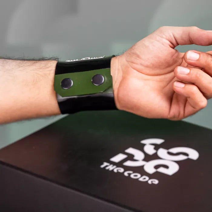 The image showcases a bold Latex Clutch Bracelet Bag, designed for a striking look. This unique accessory wraps around the wrist, combining functionality with edgy style. Featuring a distinctive graphic design, it embodies the essence of avant-garde fashion, making it a perfect statement piece for any occasion.