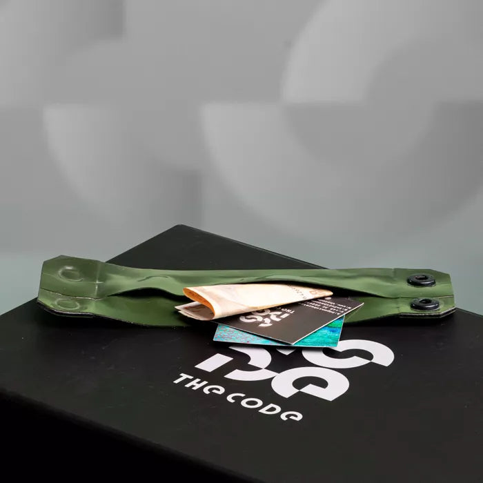 The image showcases a bold Latex Clutch Bracelet Bag, designed for a striking look. This unique accessory wraps around the wrist, combining functionality with edgy style. Featuring a distinctive graphic design, it embodies the essence of avant-garde fashion, making it a perfect statement piece for any occasion.