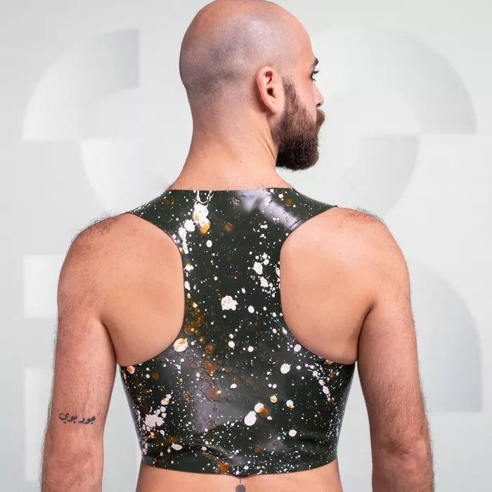 The image features the Latex Splash Cropped Tank Top, showcasing a bold design with splatter patterns in green and contrasting colors. This striking piece offers a modern, edgy look, making it perfect for those who want to make a statement. Its sleek fit highlights the wearer's physique, ideal for both clubwear and performance settings.