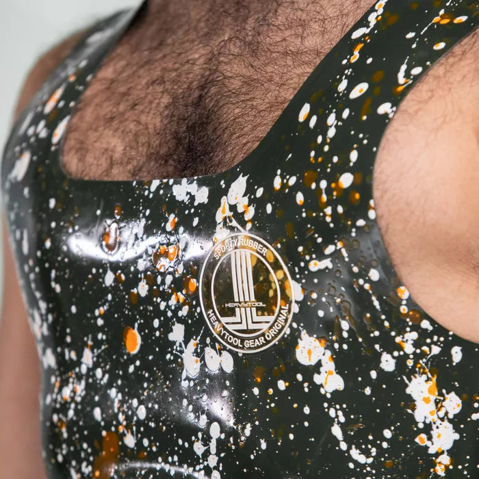 The image features the Latex Splash Cropped Tank Top, showcasing a bold design with splatter patterns in green and contrasting colors. This striking piece offers a modern, edgy look, making it perfect for those who want to make a statement. Its sleek fit highlights the wearer's physique, ideal for both clubwear and performance settings.