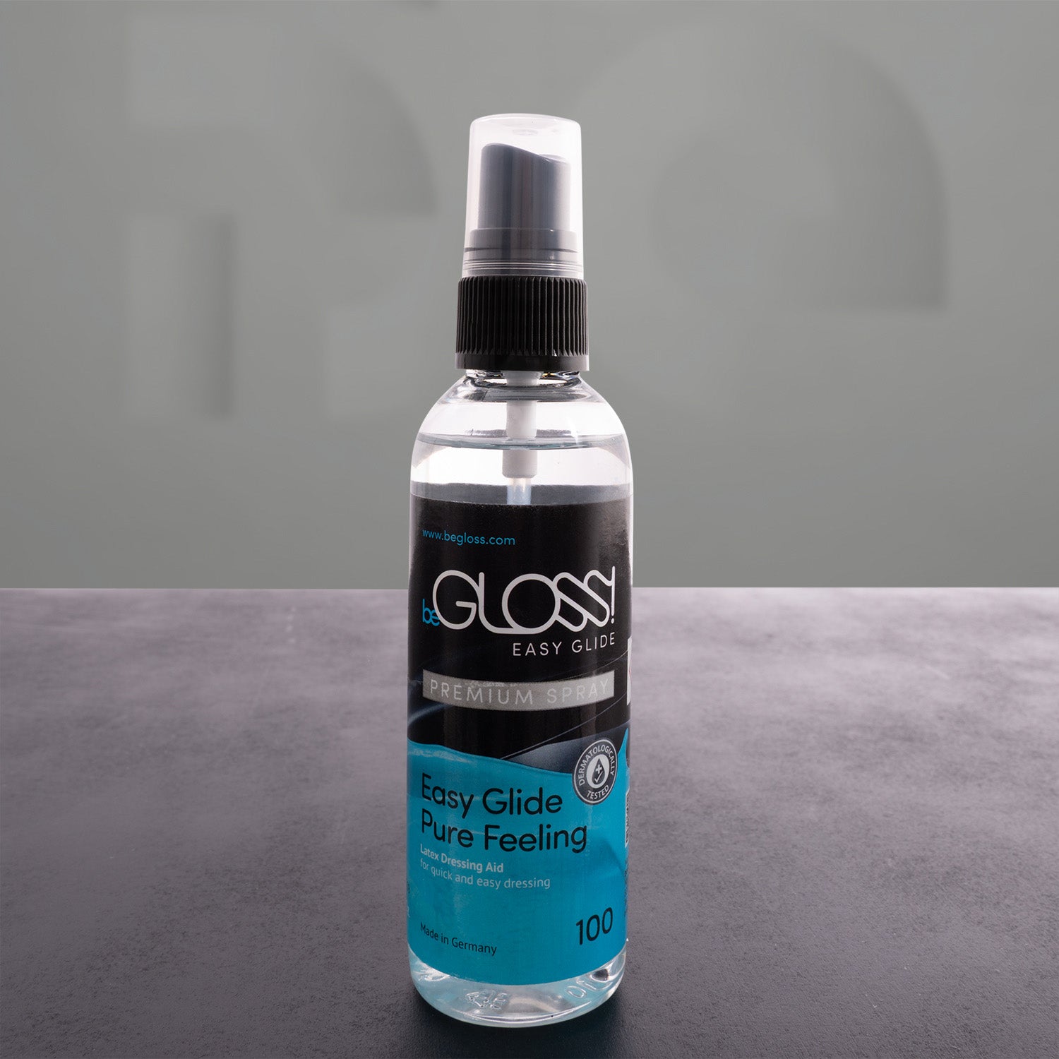 latex polish bottle in front of a grey background