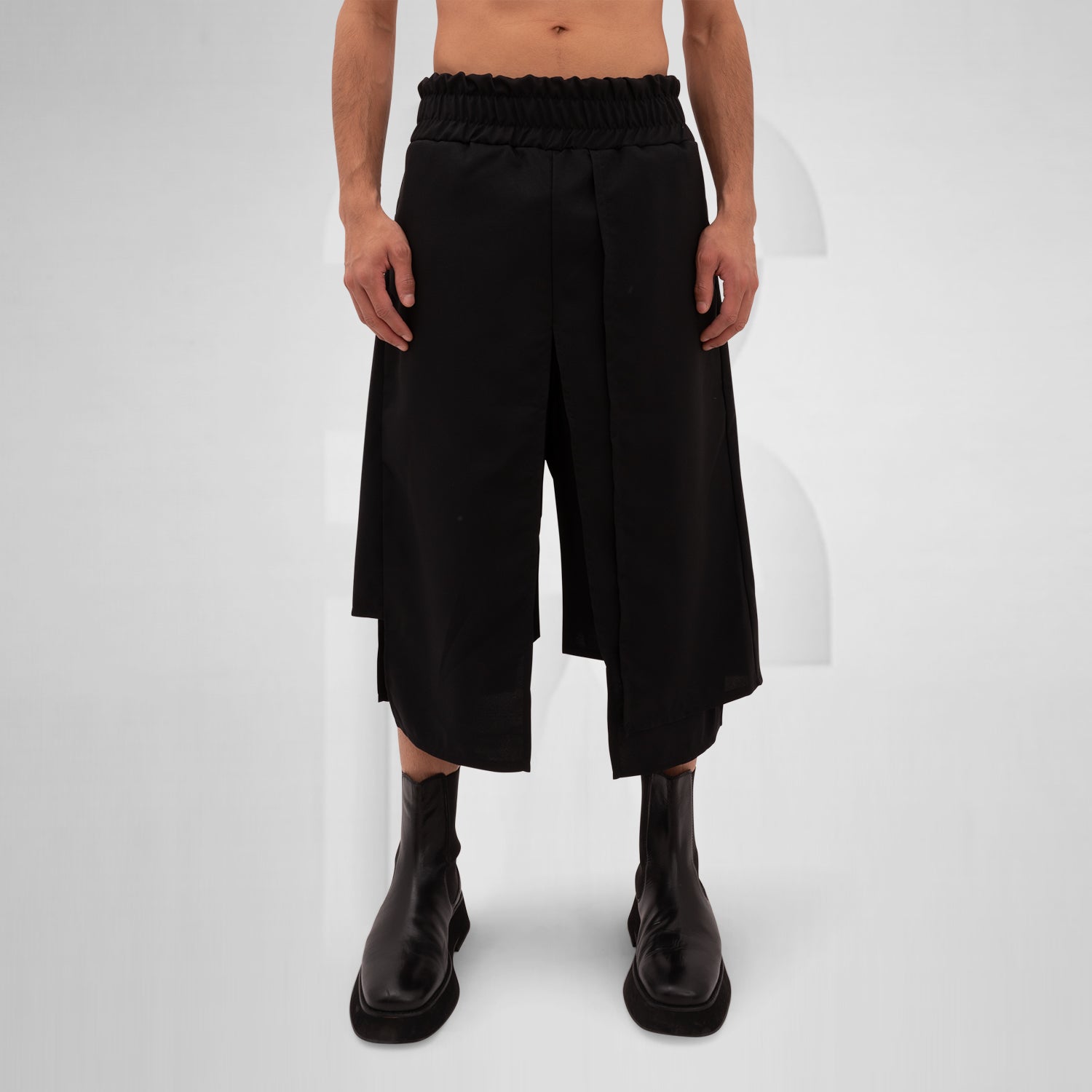 The Layered Bootcut Shorts Mixed from This is Fred present a striking silhouette that embodies contemporary fashion innovation. With a unique layered design in sleek black, these shorts offer a perfect blend of style and comfort, making them versatile for both energetic dance floors and stylish outings. The elasticated waistband ensures a comfortable fit, while the bootcut style adds a modern edge.