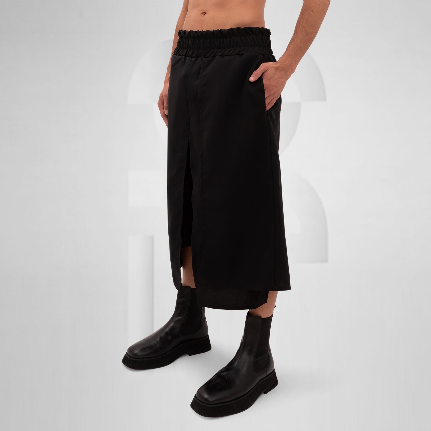 The Layered Bootcut Shorts Mixed from This is Fred present a striking silhouette that embodies contemporary fashion innovation. With a unique layered design in sleek black, these shorts offer a perfect blend of style and comfort, making them versatile for both energetic dance floors and stylish outings. The elasticated waistband ensures a comfortable fit, while the bootcut style adds a modern edge.