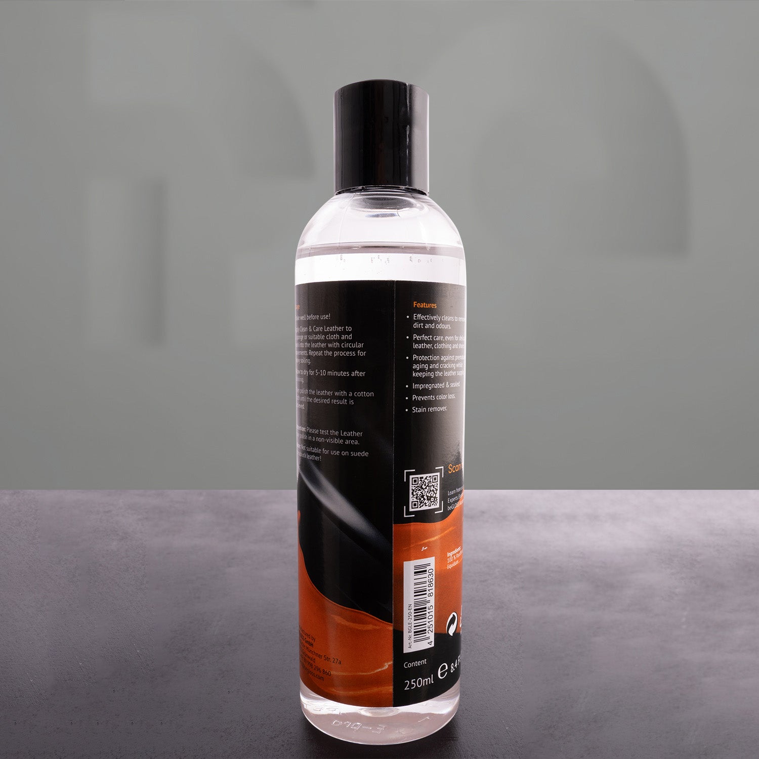 leather polish bottle in front of a grey background
