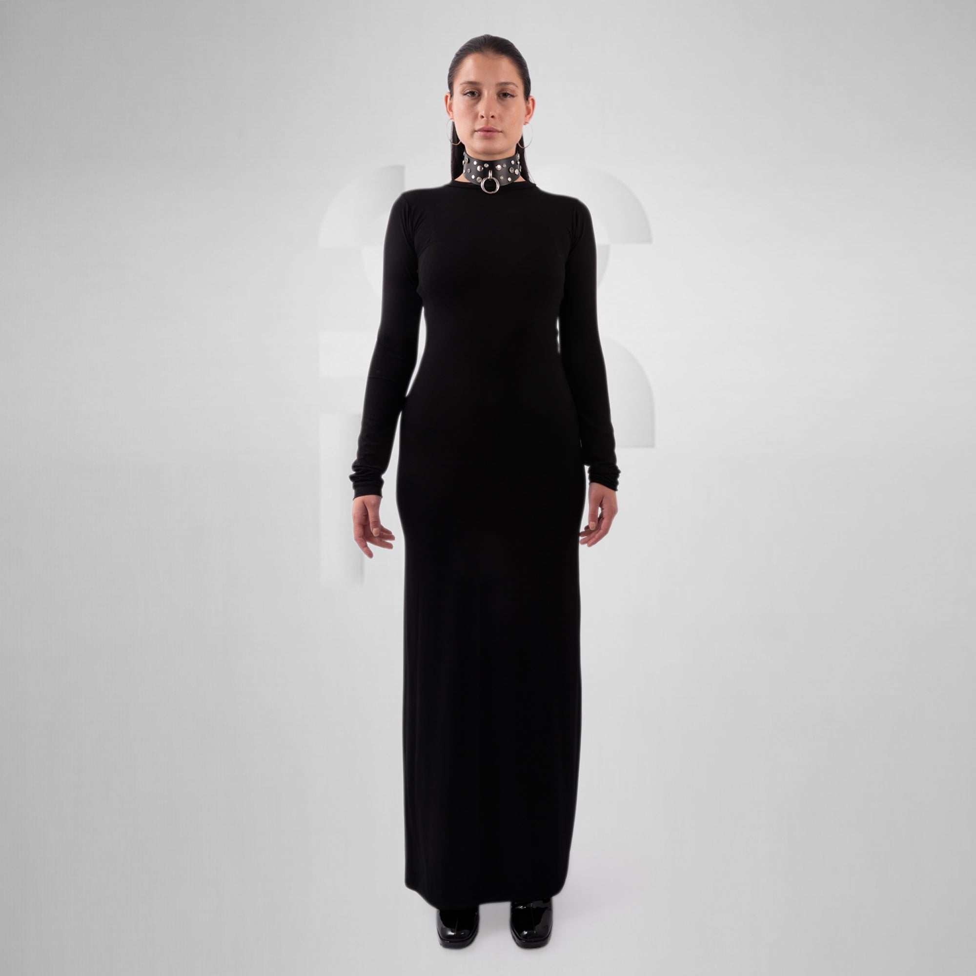 Woman wearing a long black dress on a white background