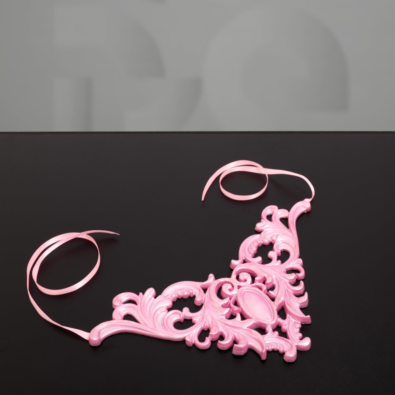 Introducing a stunning and opulent accessory that beautifully captures the essence of the Baroque era: the pink latex choker with a Baroque-style design.